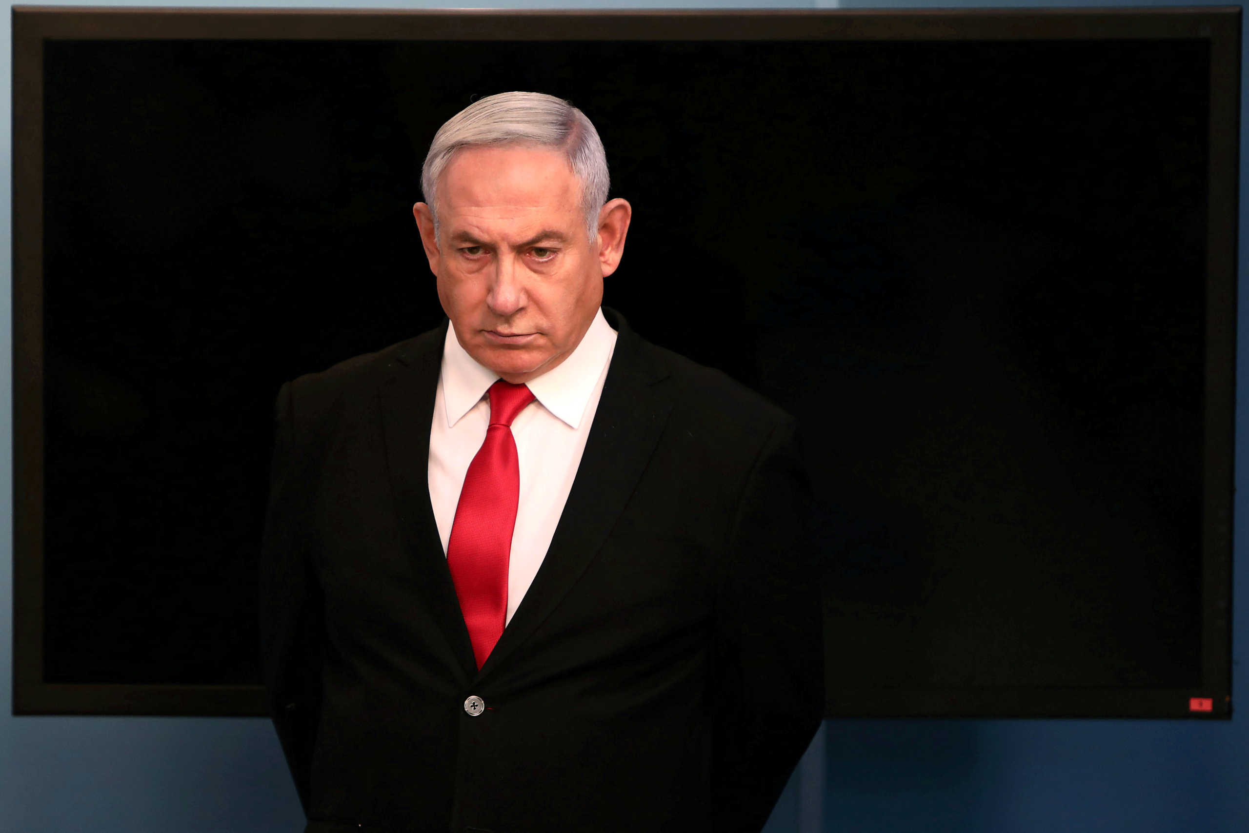 FILE PHOTO: Israeli Prime Minister Benjamin Netanyahu arrives for a speech at his Jerusalem office, regarding the new measures that will be taken to fight the coronavirus, March 14, 2020. Gali Tibbon