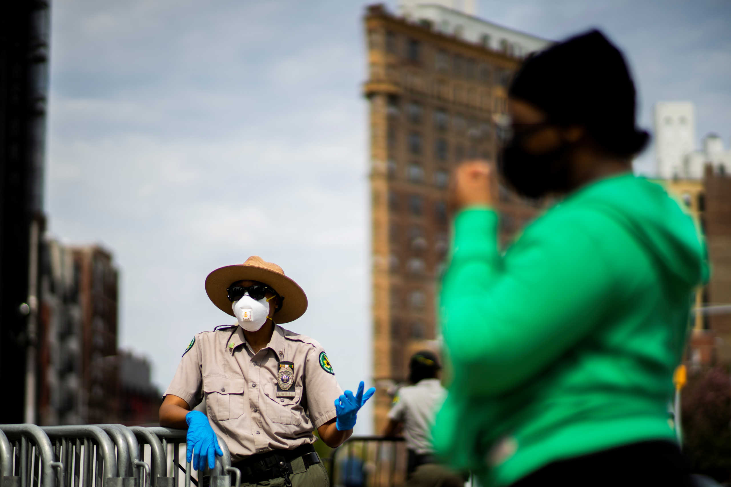 An Urban Park Ranger talks with people after running out of masks during a free mask distribution to people at Grand Army Plaza, during the outbreak of the coronavirus disease (COVID-19) in the Brooklyn borough of New York City, New York, U.S., May 3, 2020. REUTERS