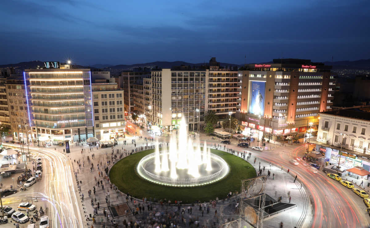 People gather around the fountain of the newly renovated Omonia square, in Athens, Greece, May 14, 2020. Picture taken with long exposure. REUTERS