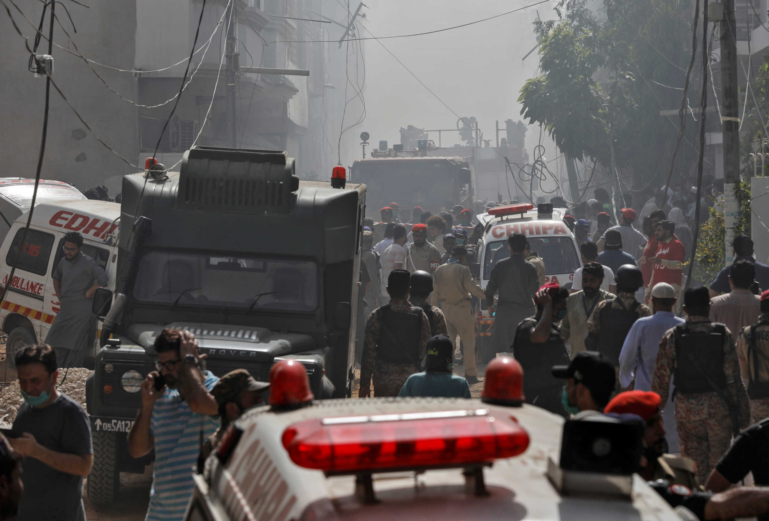 Ambulances and fire brigade vehicles gather at the site of a passenger plane crash in a residential area near an airport in Karachi, Pakistan May 22, 2020. REUTERS