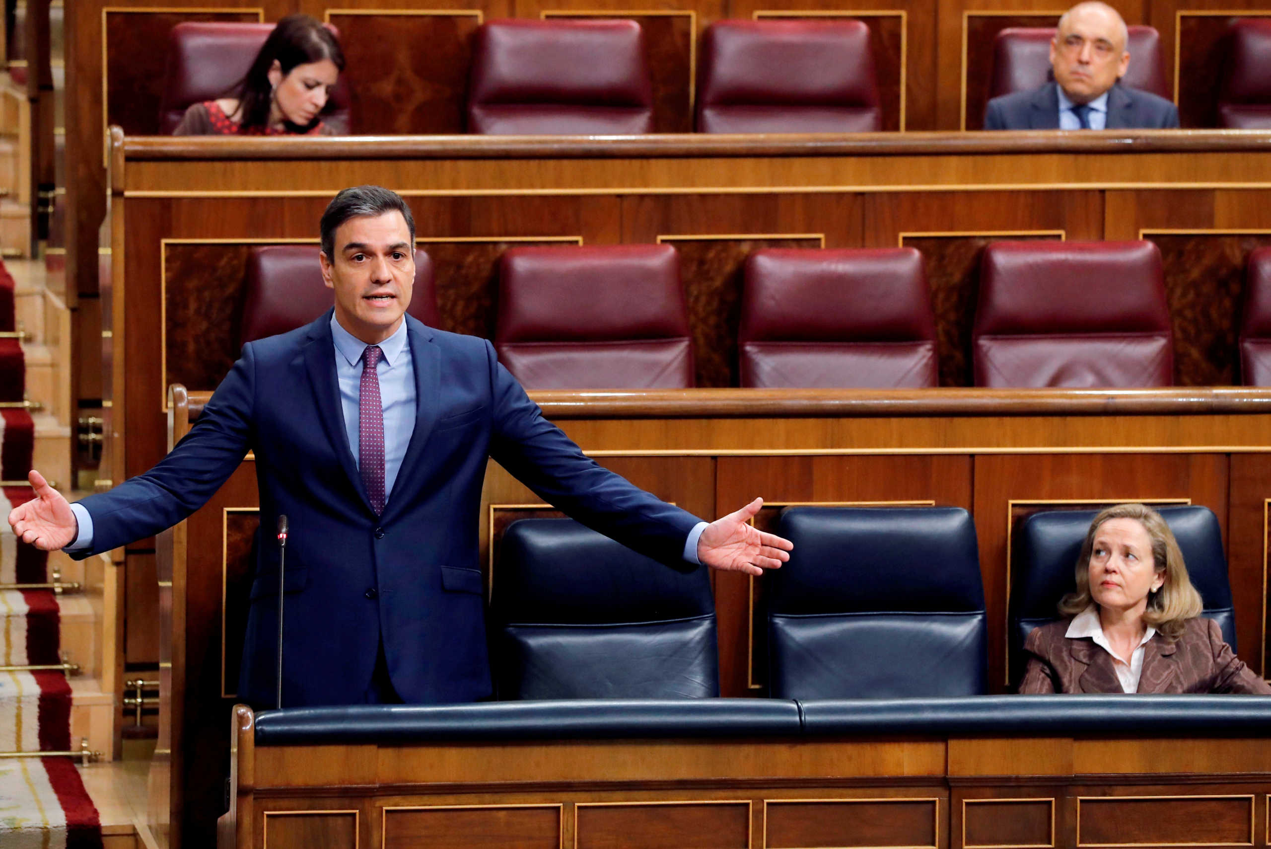 Spanish Prime Minister Pedro Sanchez answers questions as he keeps social distance from Deputy Prime Minister and Economic Affairs Minister Nadia Calvino during a control session on coronavirus disease (COVID-19) at the Parliament in Madrid, Spain, April 15, 2020. Ballesteros