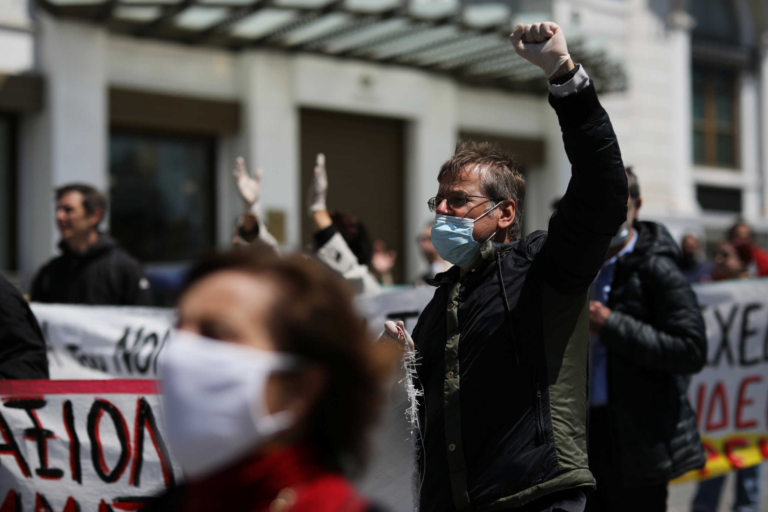 Greek teachers and students wearing protective face masks take part in a protest against government educational reforms, following the coronavirus disease (COVID-19) outbreak, in Athens, Greece, April 24, 2020. REUTERS