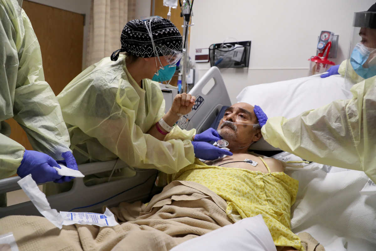 Co-director of the intensive care unit at CommonSpirit's Dignity Health California Hospital Medical Center, Dr. Zafia Anklesaria, 35, who is seven months pregnant, removes a tracheostomy tube from COVID-19 patient Vicente Arredondo, 65, in the intensive care unit at the hospital where she works, during the coronavirus disease (COVID-19) outbreak, in Los Angeles, California, U.S., May 18, 2020. "Yay, you did it, you are officially liberated!" said  Anklesaria to Arredondo after she removed the tube. REUTERS
