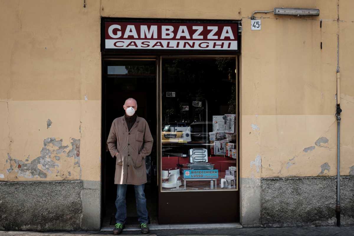 Life in Italy's original 'red zones': The owner of Gambazza Casalinghi stands at the entrance of his home electronics shop in Codogno, the small northern town where Italy's first patient was diagnosed with the coronavirus disease (COVID-19) on February 21, as the country begins a staged end to a nationwide lockdown, in this picture taken by schoolteacher Marzio Toniolo, May 4, 2020. Many owners in the town are not allowing customers inside their shops, and instead taking orders from outside to try and avoid contagion. Codogno residents had been on lockdown for over 10 weeks, as they were part of a small cluster of northern towns where cases and deaths immediately surged after the first patient was diagnosed. Picture taken May 4, 2020. Marzio Toniolo via REUTERS THIS IMAGE HAS BEEN SUPPLIED BY A THIRD PARTY. MANDATORY CREDIT