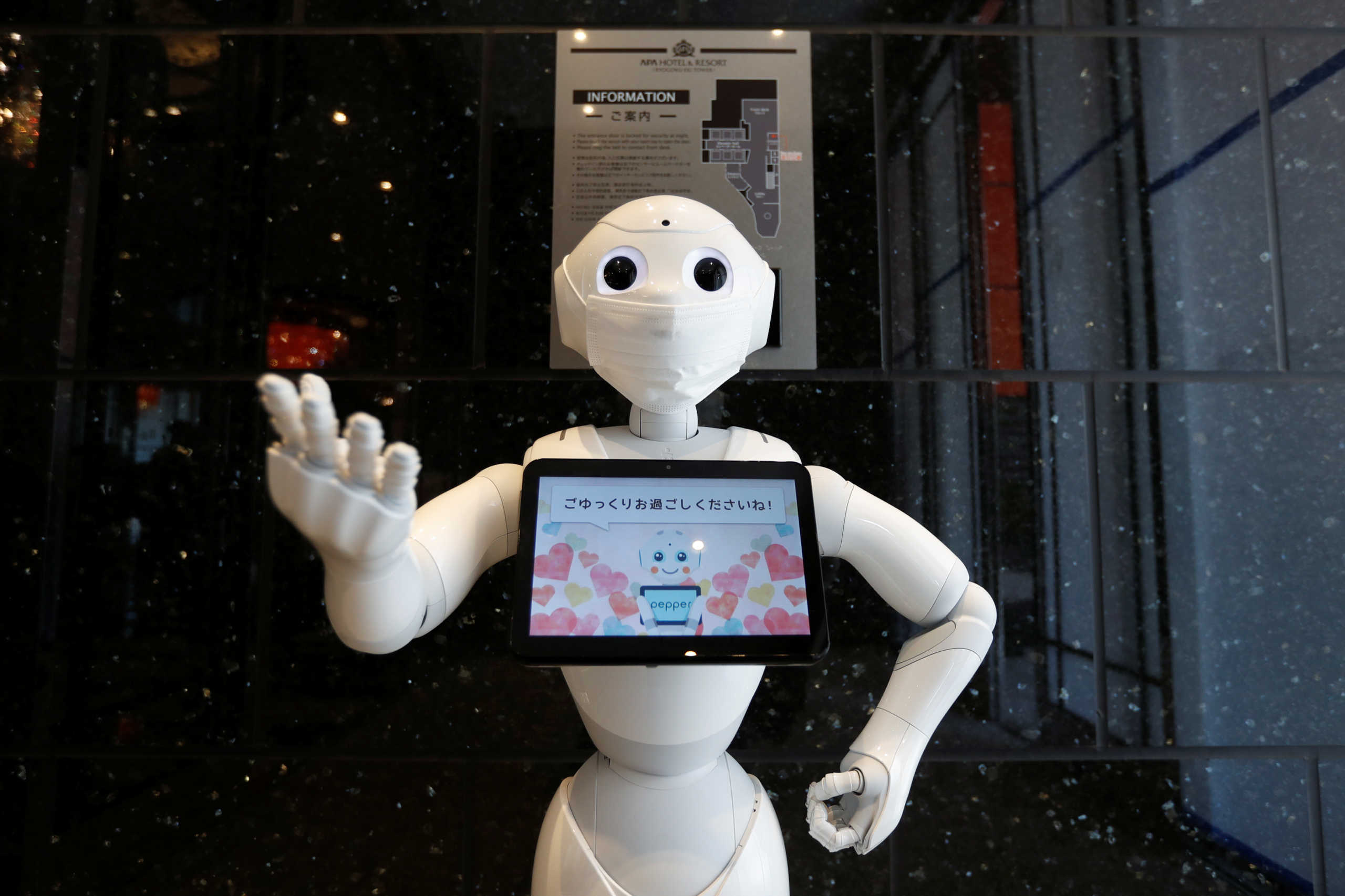 A Pepper humanoid robot, manufactured by SoftBank Group Corp. demonstrates how to check-in in a hotel of APA Group that has been designated to accommodate asymptomatic people and those with light symptoms of the coronavirus disease (COVID-19) to free up hospital beds and alleviate work by nurses and staff members, in Tokyo, Japan May 1, 2020. REUTERS