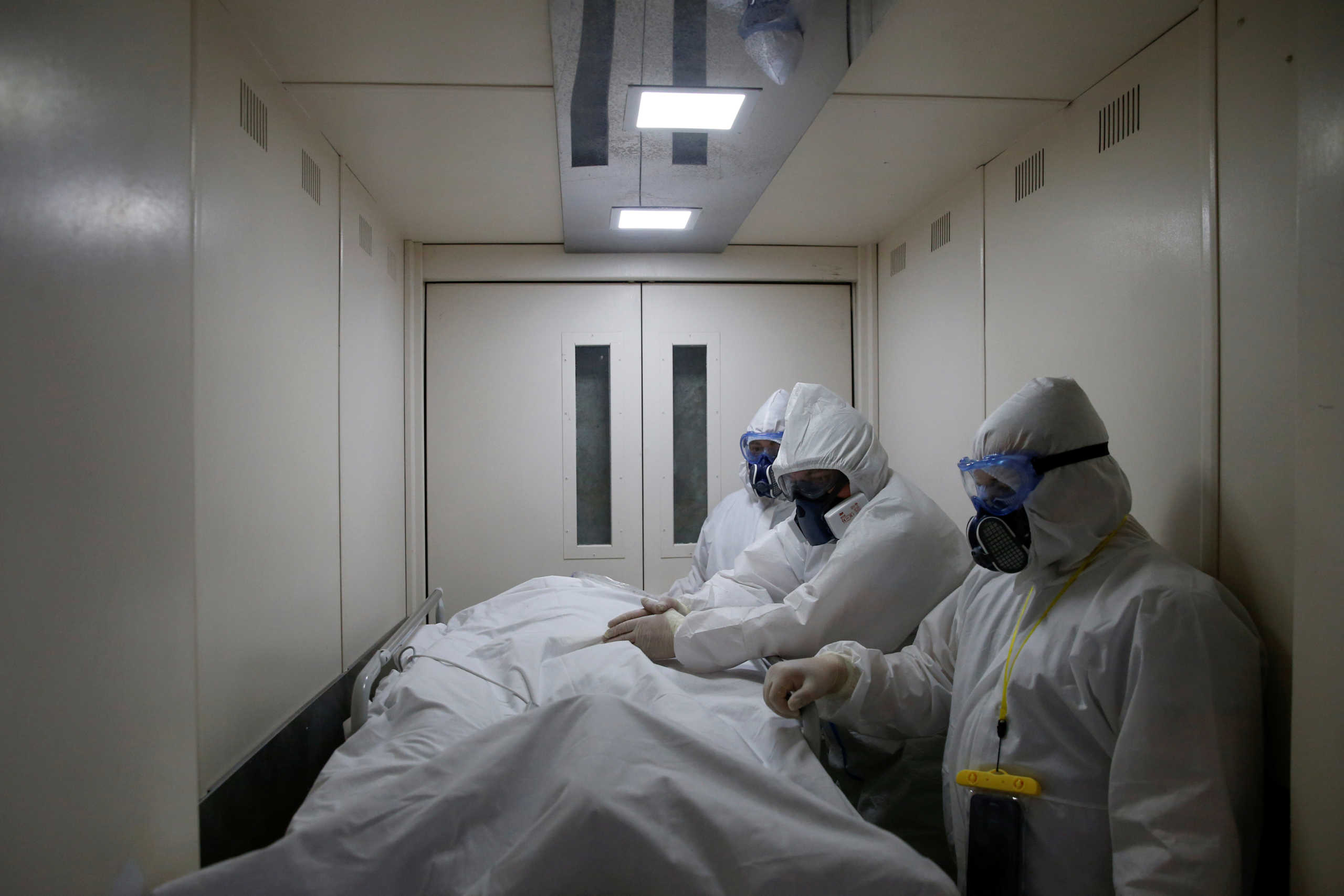 FILE PHOTO: Medical workers wearing personal protective equipment (PPE) transfer a patient suffering from the coronavirus disease (COVID-19) at the City Clinical Hospital Number 52 in Moscow, Russia April 28, 2020. Picture taken April 28, 2020. REUTERS