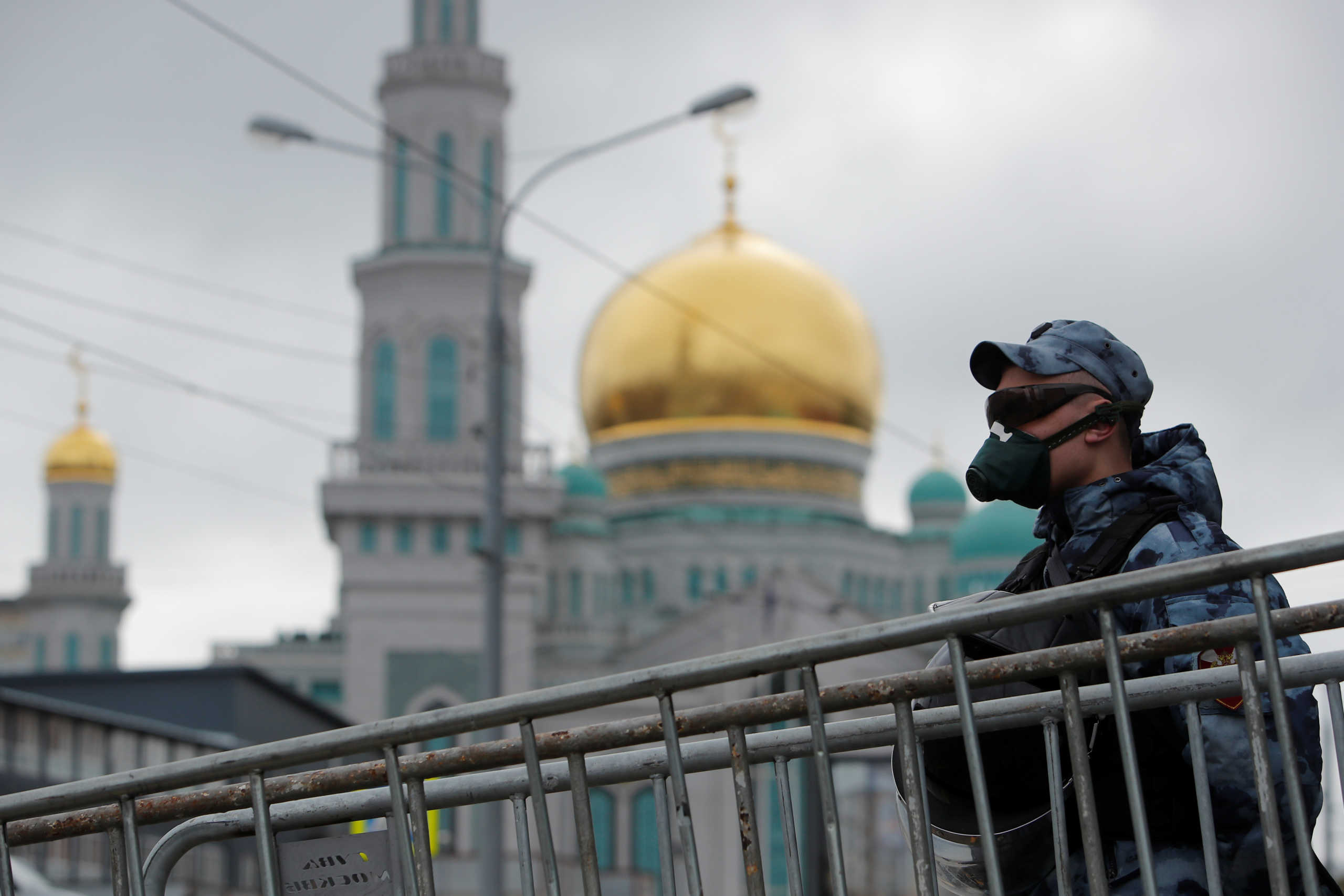 A law enforcement officer stands guard outside the closed Moscow Cathedral Mosque during Eid al-Fitr, the Muslim festival marking the end the holy fasting month of Ramadan, amid the coronavirus disease (COVID-19) outbreak in Moscow, Russia May 24, 2020. REUTERS