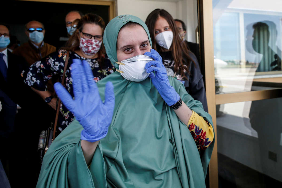 Silvia Romano, an Italian aid worker who was kidnapped by gunmen in Kenya 18 months ago, waves at Ciampino military airport in Rome, Italy, May 10, 2020. Italian Ministry of Foreign Affairs