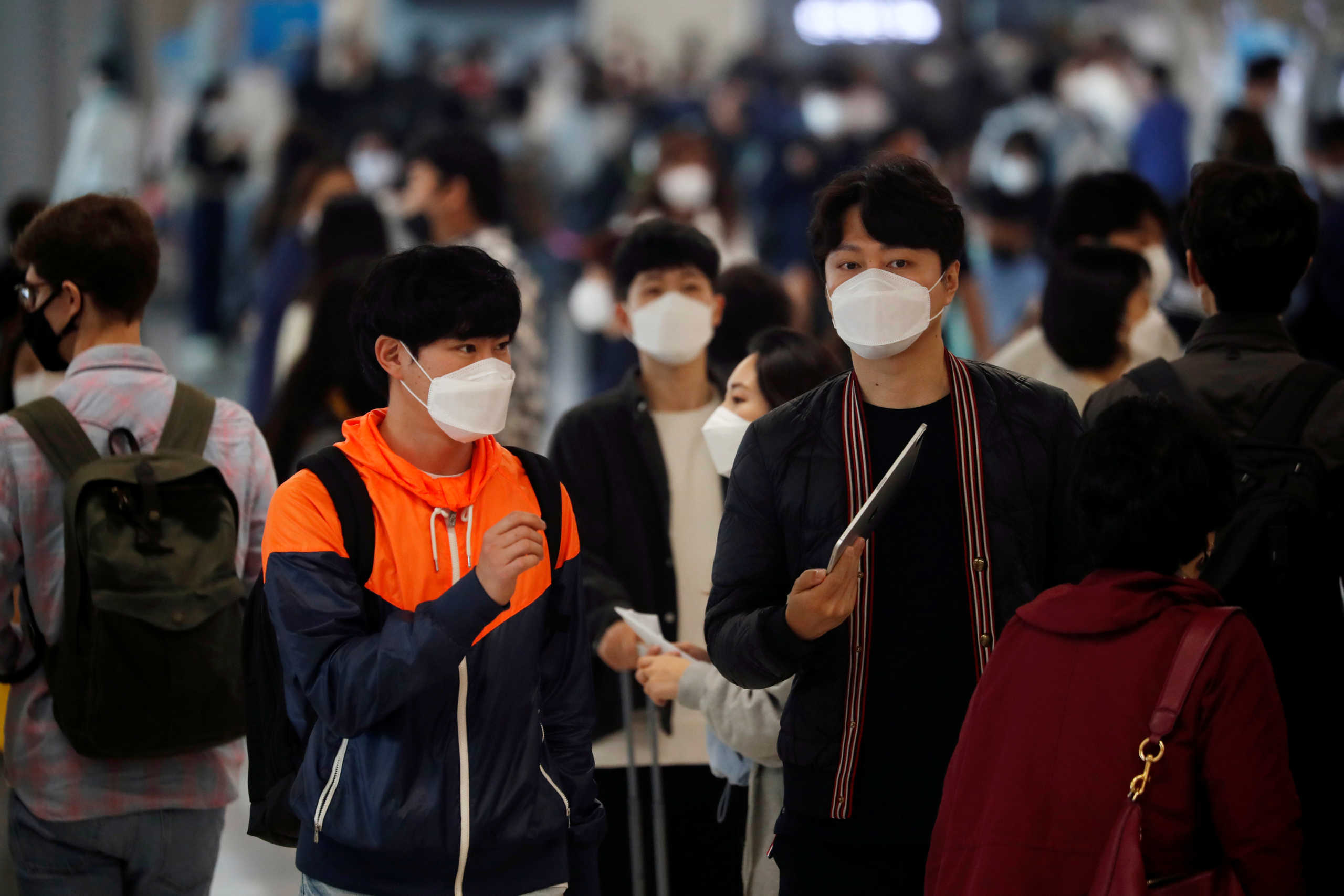People wearing masks to avoid the spread of the coronavirus disease (COVID-19) arrive at Gimpo international airport in Seoul, South Korea, May 1, 2020.   REUTERS