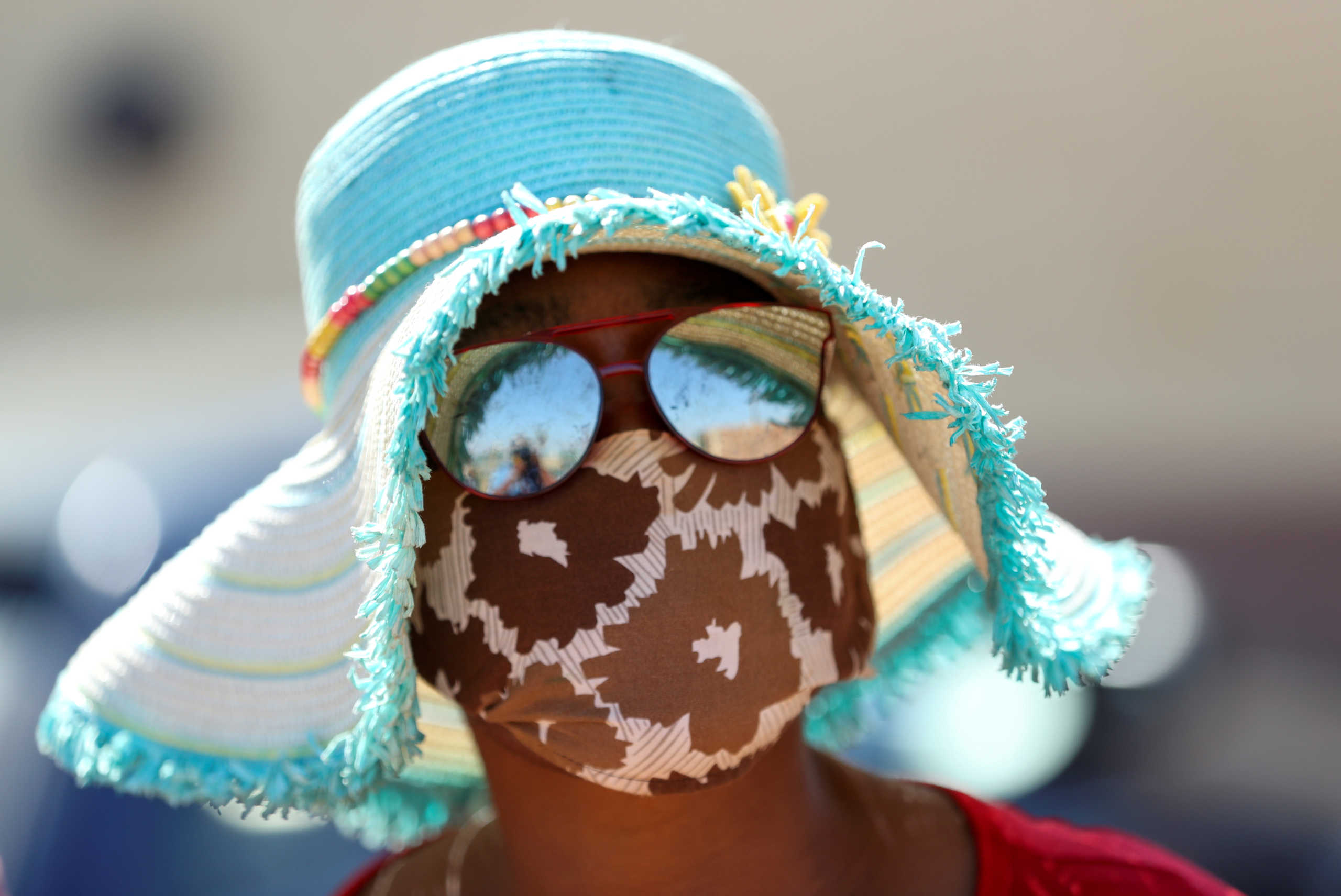 A woman wears a protective face mask during food distribution, as South Africa starts to relax some aspects of a stringent nationwide coronavirus disease (COVID-19) lockdown, in Diepsloot near Johannesburg, South Africa, May 8, 2020. REUTERS