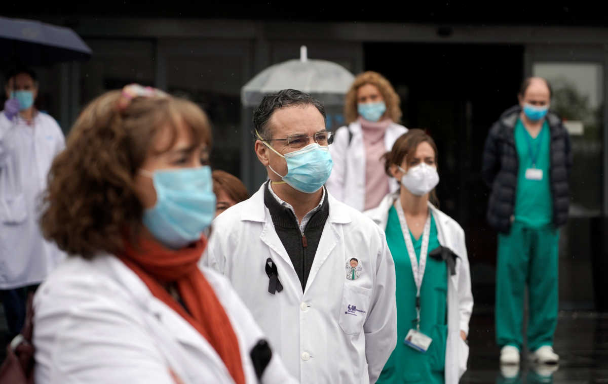 Staff from La Paz hospital react after two minutes of silence for health workers that died of COVID-19, amid the coronavirus disease (COVID-19) outbreak in Madrid, Spain, May 14, 2020. REUTERS