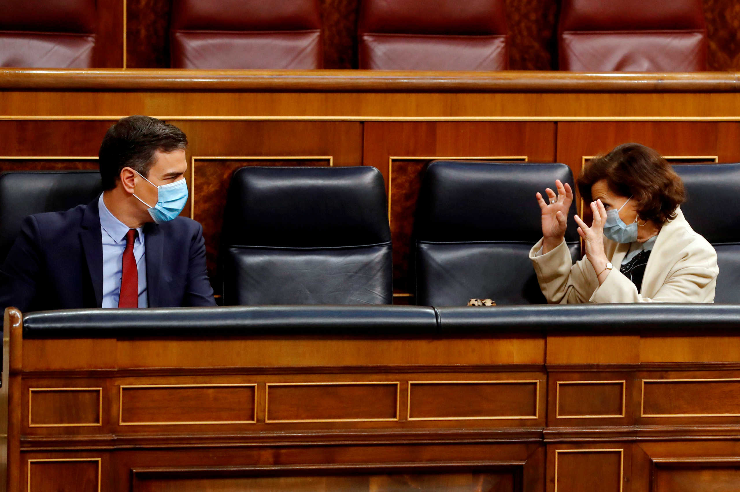 Spanish Prime Minister Pedro Sanchez listens to Deputy Prime Minister Carmen Calvo during a plenary session amid the coronavirus disease (COVID-19) outbreak, at the Parliament in Madrid, Spain, May 20, 2020. Ballesteros
