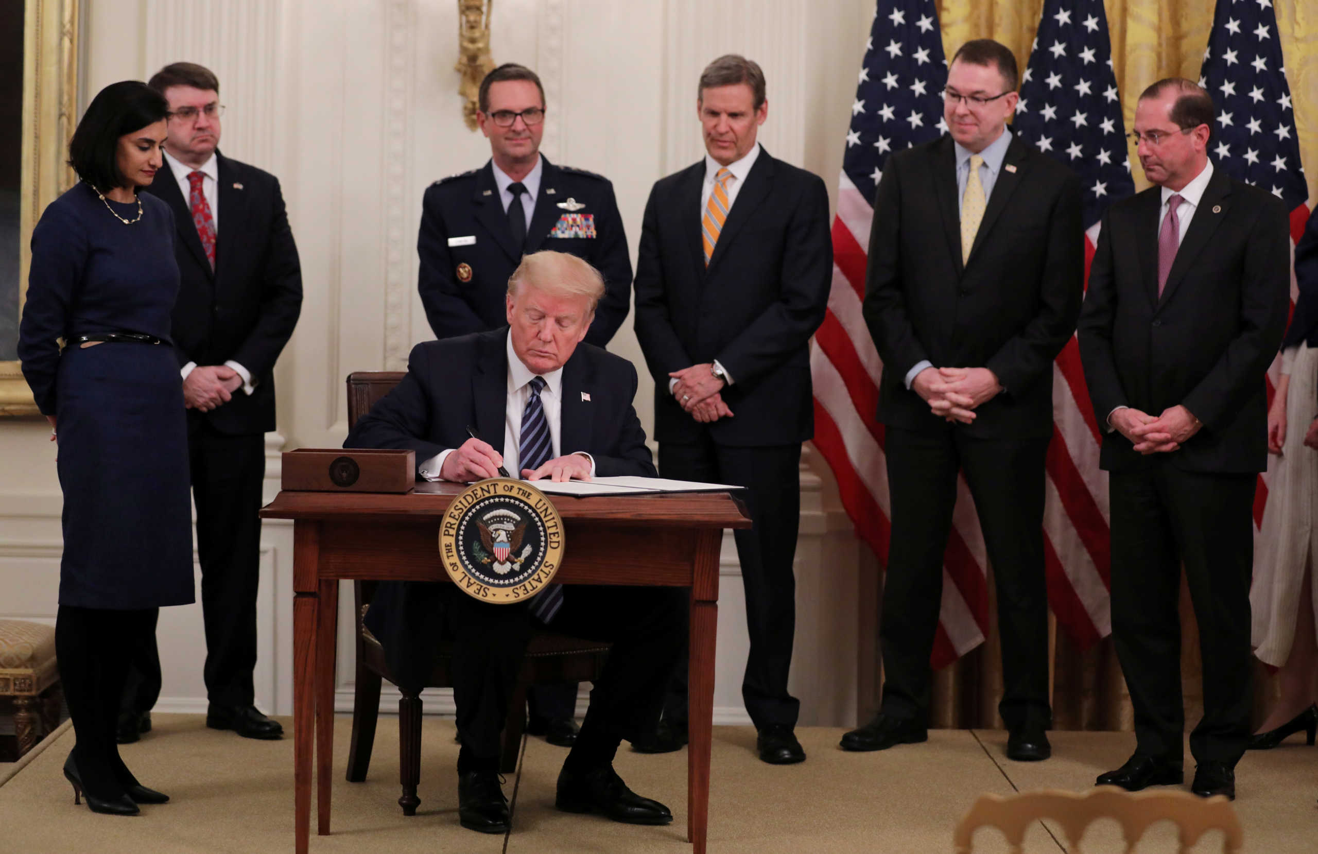 U.S. President Donald Trump signs a presidential proclamation declaring an "Older Americans Month 2020" during an event about senior citizens and the coronavirus disease (COVID-19) pandemic in the East Room at the White House in Washington, U.S., April 30, 2020. REUTERS