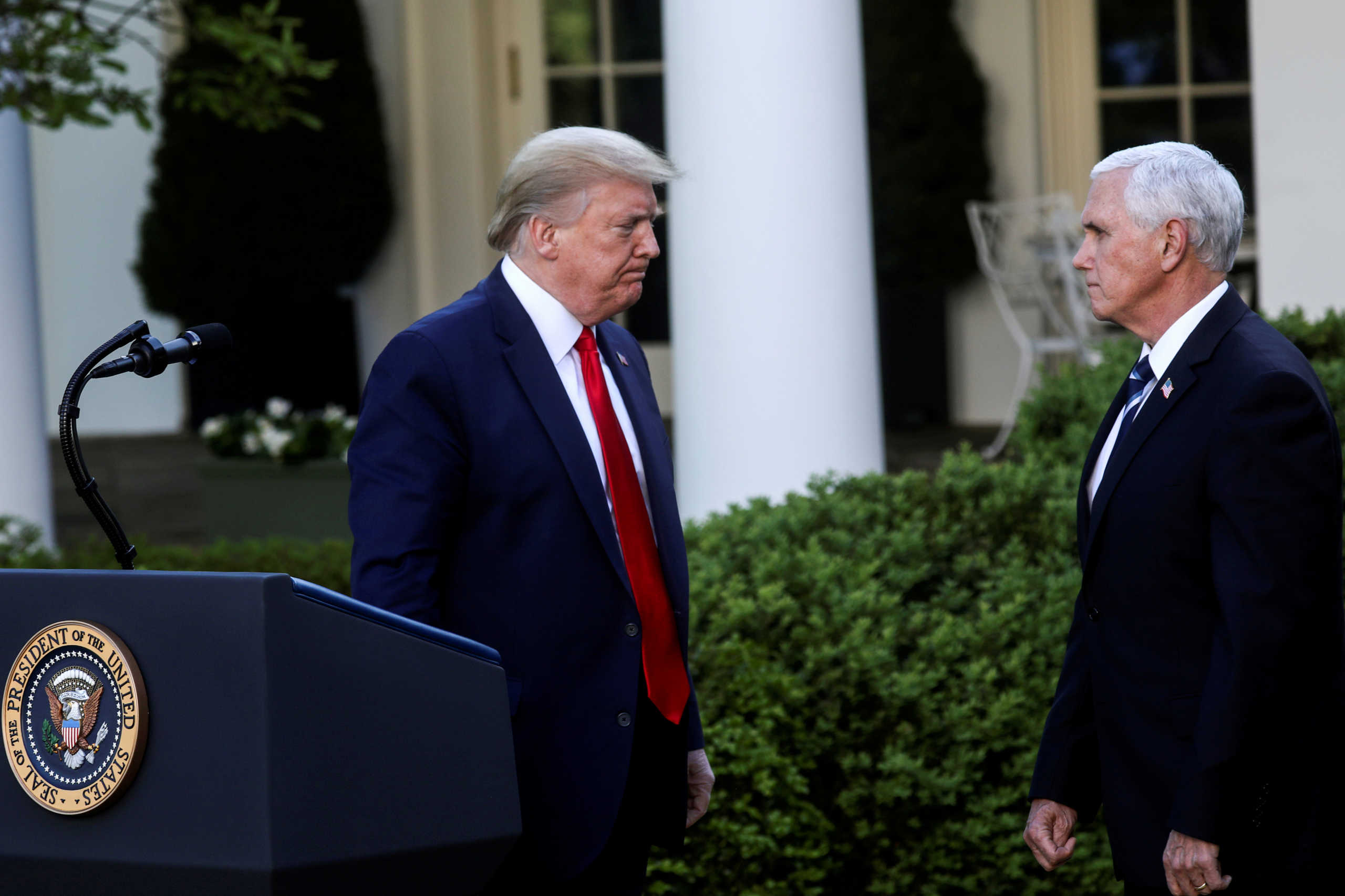 FILE PHOTO: U.S. President Donald Trump turns to Vice President Mike Pence as they depart following a coronavirus response news conference in the Rose Garden at the White House in Washington, U.S., April 27, 2020. REUTERS