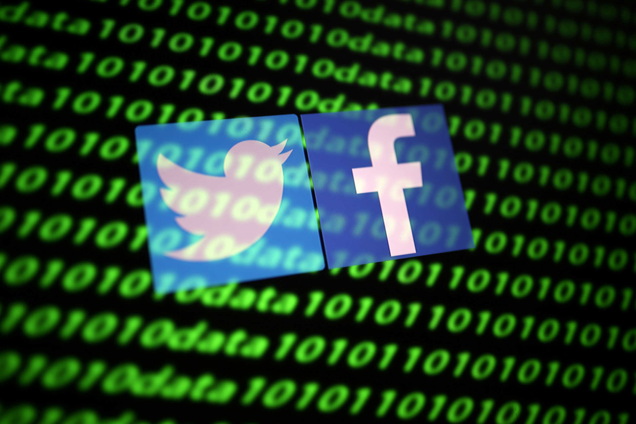 FILE PHOTO: The Twitter and Facebook logo along with binary cyber codes are seen in this illustration taken November 26, 2019. REUTERS