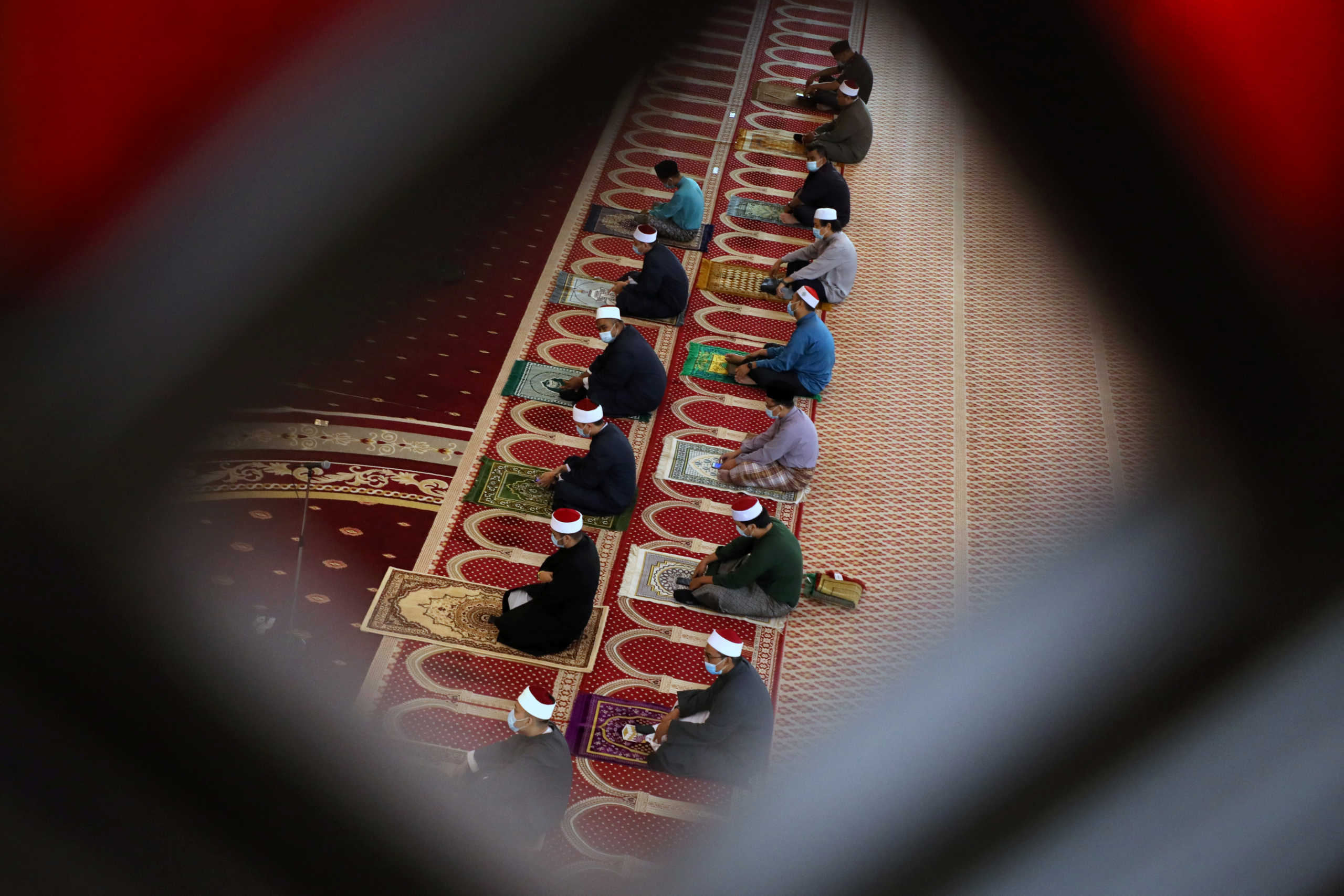 Muslims wearing protective face masks and following social distancing measures pray inside the National mosque as Malaysia eases a ban on mass prayers in mosques, amid the coronavirus disease (COVID-19) outbreak, in Kuala Lumpur, Malaysia May 15, 2020. REUTERS