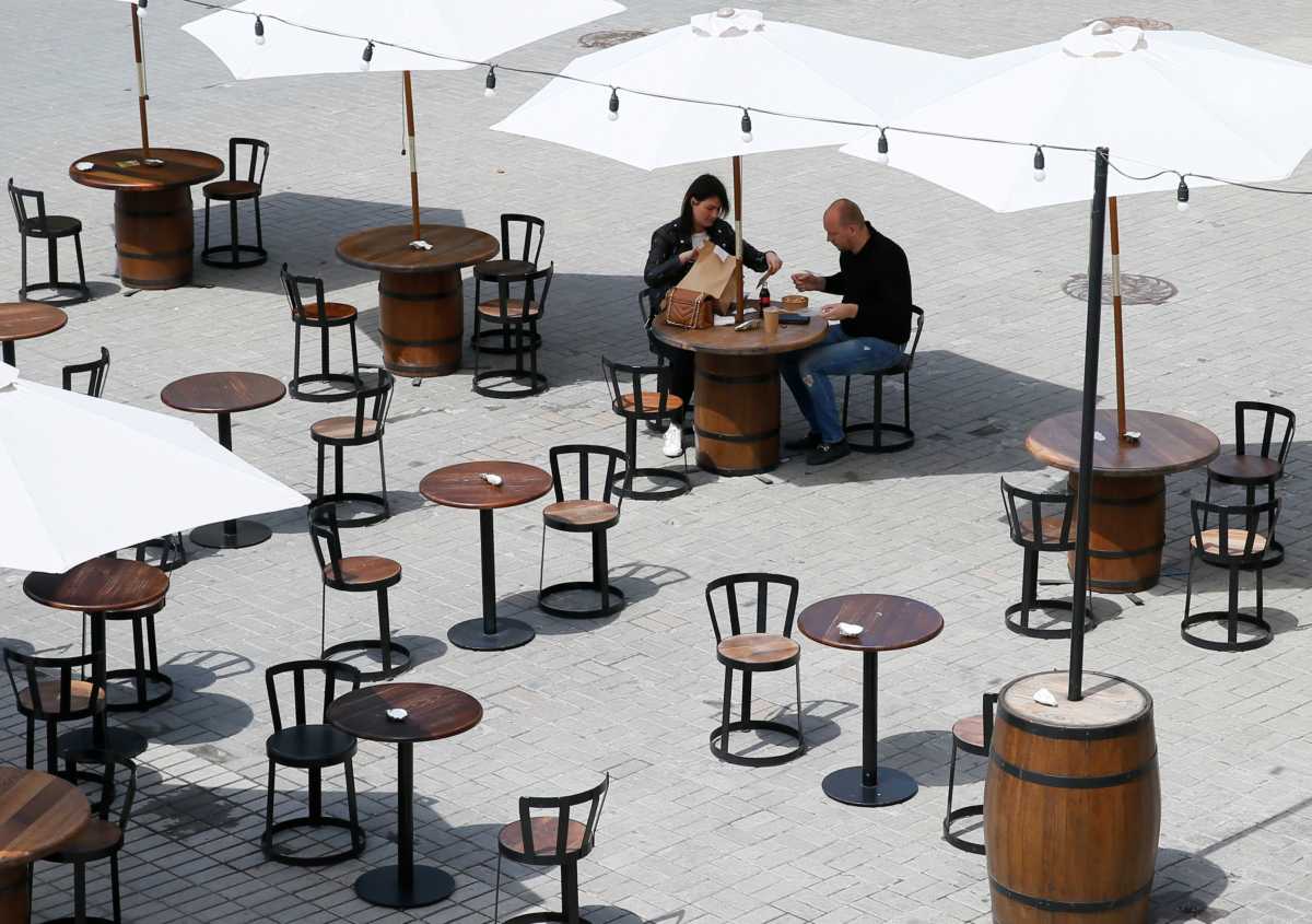 People eat their food at the terrace of a cafe after some restrictions were lifted amid the outbreak of the coronavirus disease (COVID-19) in Kiev, Ukraine May 15, 2020.  REUTERS