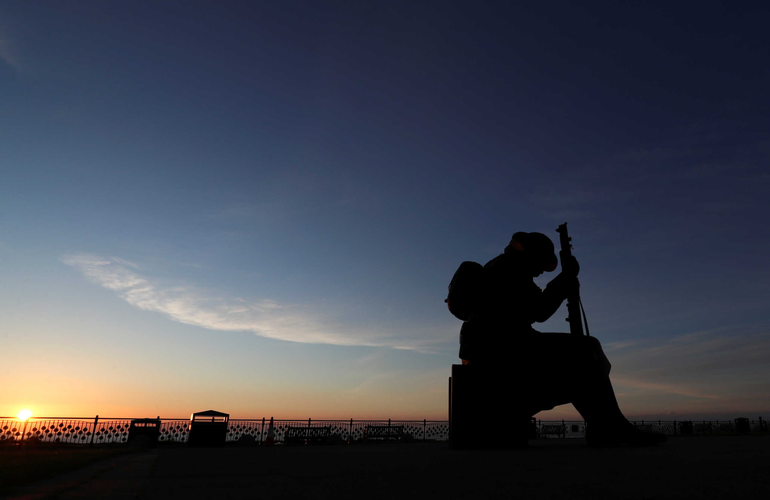 The statue of soldier 'Tommy', a war statue by artist Ray Lonsdale, is seen during sunrise on the 75th Anniversary of VE Day, in Seaham, Britain May 8, 2020. REUTERS