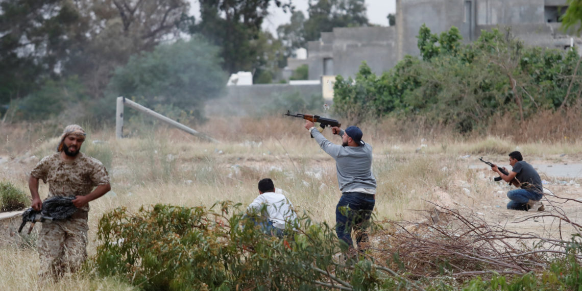 A fighter loyal to Libya's U.N.-backed government (GNA) fires an AK-47 during a clash with forces loyal to Khalifa Haftar at the outskirts of Tripoli, Libya May 21, 2019. REUTERS