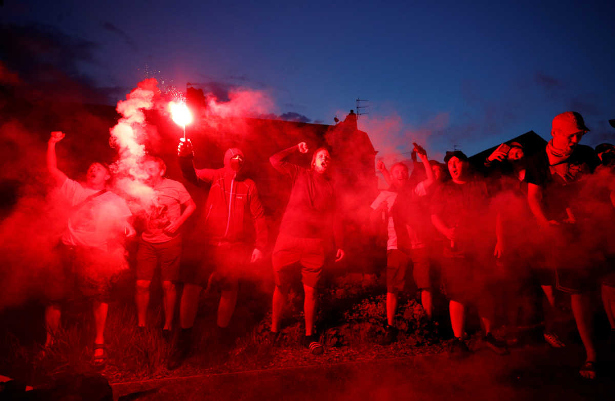Soccer Football - Premier League - Liverpool could win Premier League if Manchester city drop points against Chelsea - Liverpool, Britain - June 25, 2020  Liverpool fans celebrate with flares outside Anfield after Chelsea scored their second goal in their match against Manchester City  REUTERS