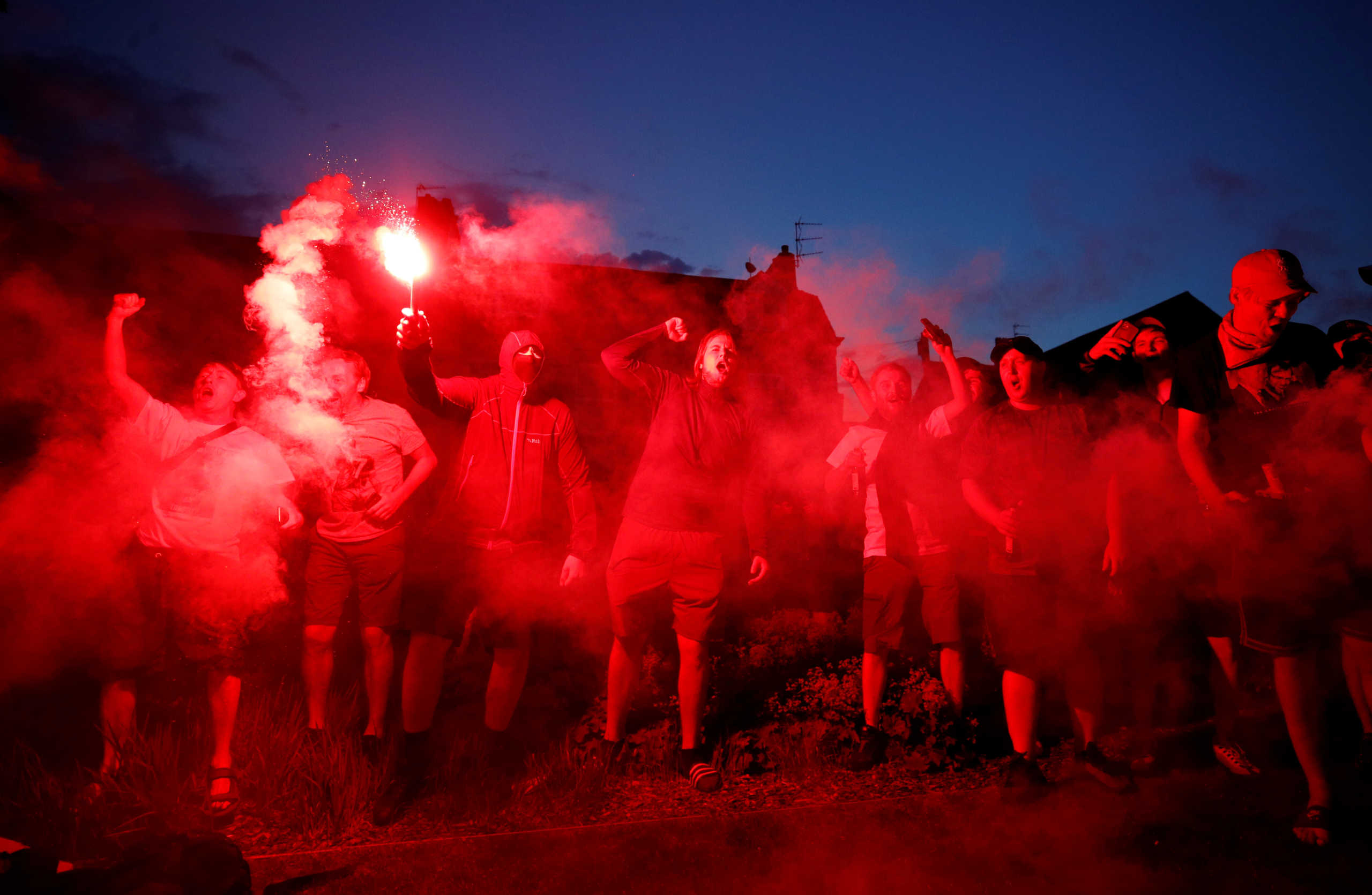 Soccer Football - Premier League - Liverpool could win Premier League if Manchester city drop points against Chelsea - Liverpool, Britain - June 25, 2020  Liverpool fans celebrate with flares outside Anfield after Chelsea scored their second goal in their match against Manchester City  REUTERS