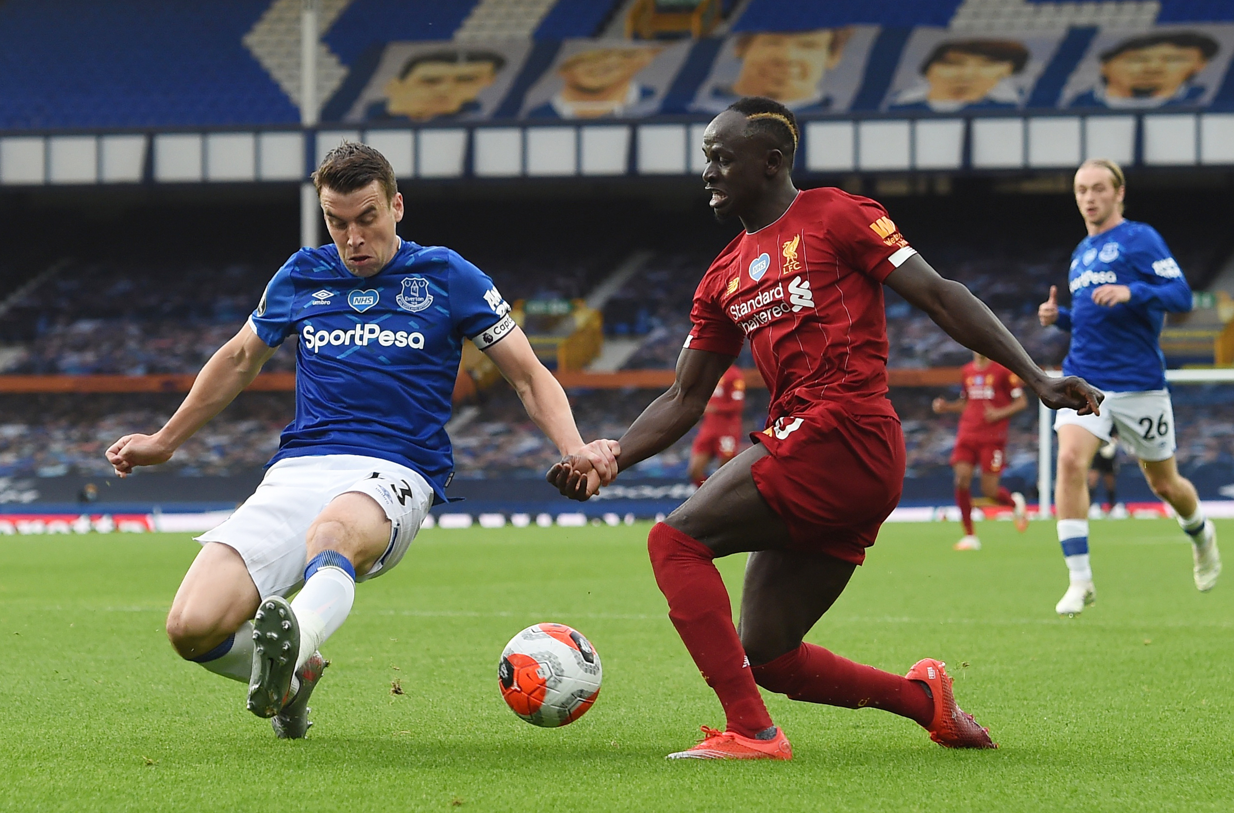 Soccer Football - Premier League - Everton v Liverpool - Goodison Park, Liverpool, Britain - June 21, 2020 Liverpool's Sadio Mane in action with Everton's Seamus Coleman, as play resumes behind closed doors following the outbreak of the coronavirus disease (COVID-19) Peter Powell