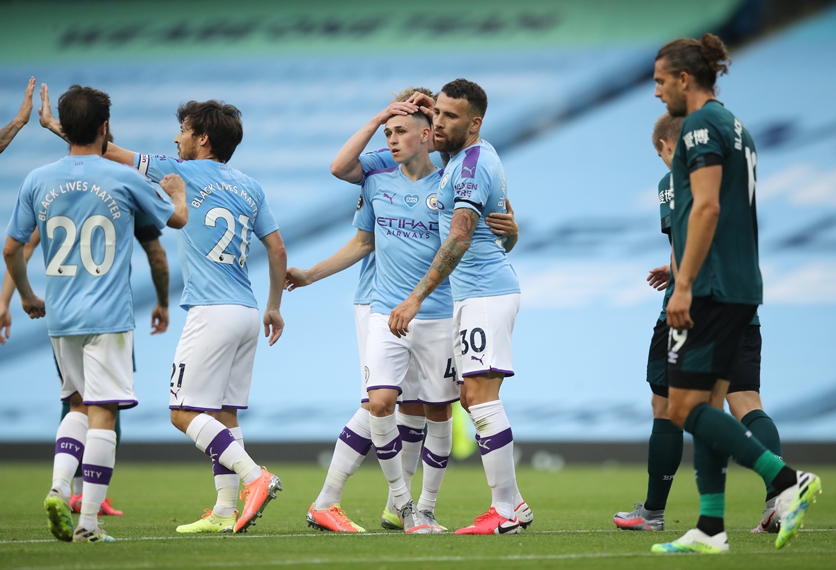 Soccer Football - Premier League - Manchester City v Burnley - Etihad Stadium, Manchester, Britain - June 22, 2020 Manchester City's Phil Foden celebrates scoring their first goal with Nicolas Otamendi and teammates, as play resumes behind closed doors following the outbreak of the coronavirus disease (COVID-19) Martin Rickett