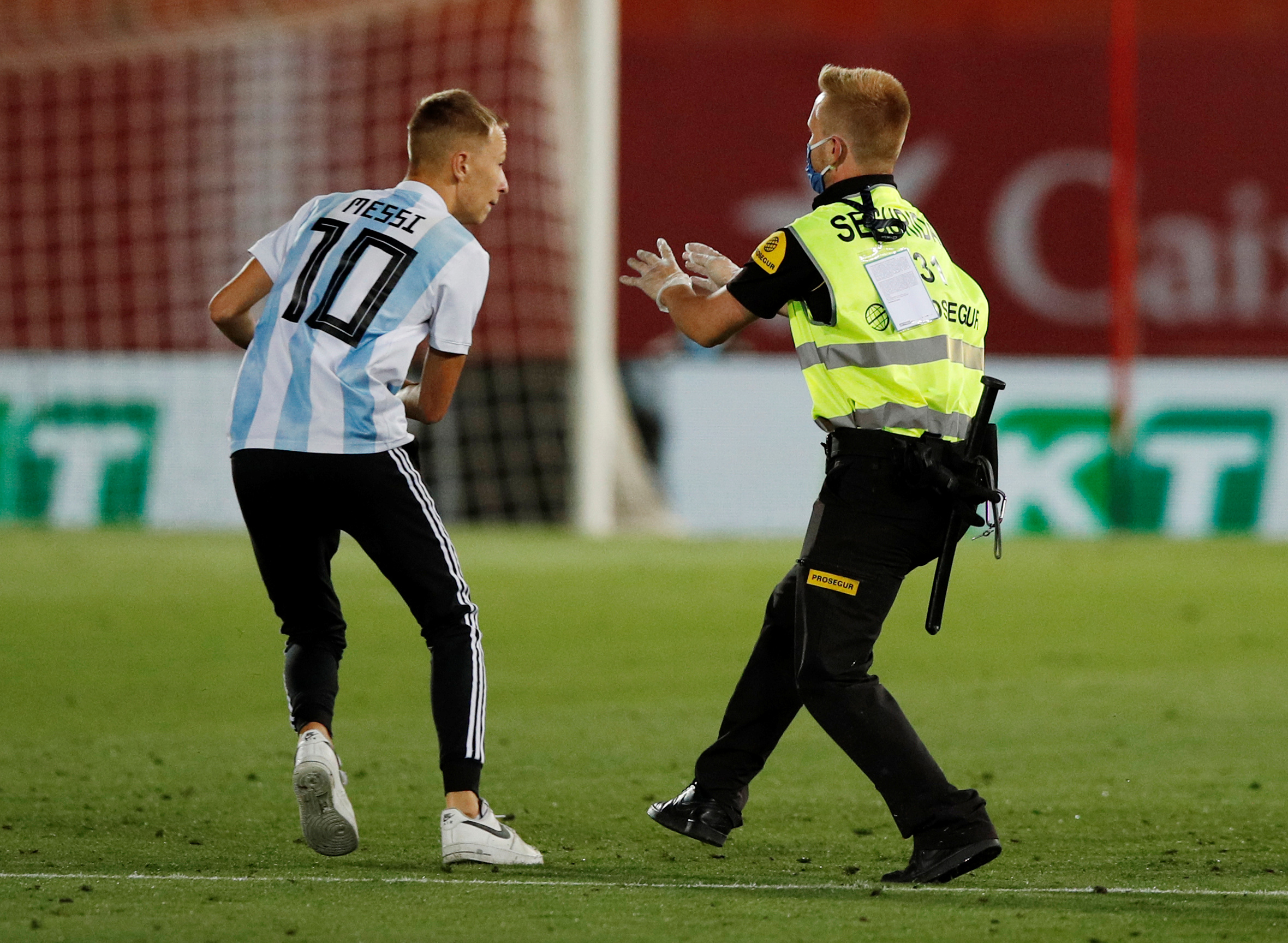 Soccer Football - La Liga Santander - RCD Mallorca v FC Barcelona - Iberostar Stadium, Palma, Spain - June 13, 2020   A fan invades the pitch during the match, as play resumes behind closed doors following the outbreak of the coronavirus disease (COVID-19)   REUTERS