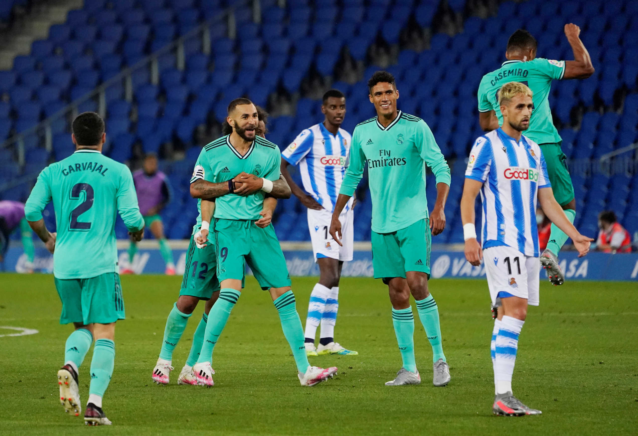 Soccer Football - La Liga Santander - Real Sociedad v Real Madrid - Reale Arena, San Sebastian, Spain - June 21, 2020   Real Madrid's Karim Benzema celebrates scoring their second goal with teammates, as play resumes behind closed doors following the outbreak of the coronavirus disease (COVID-19)   REUTERS