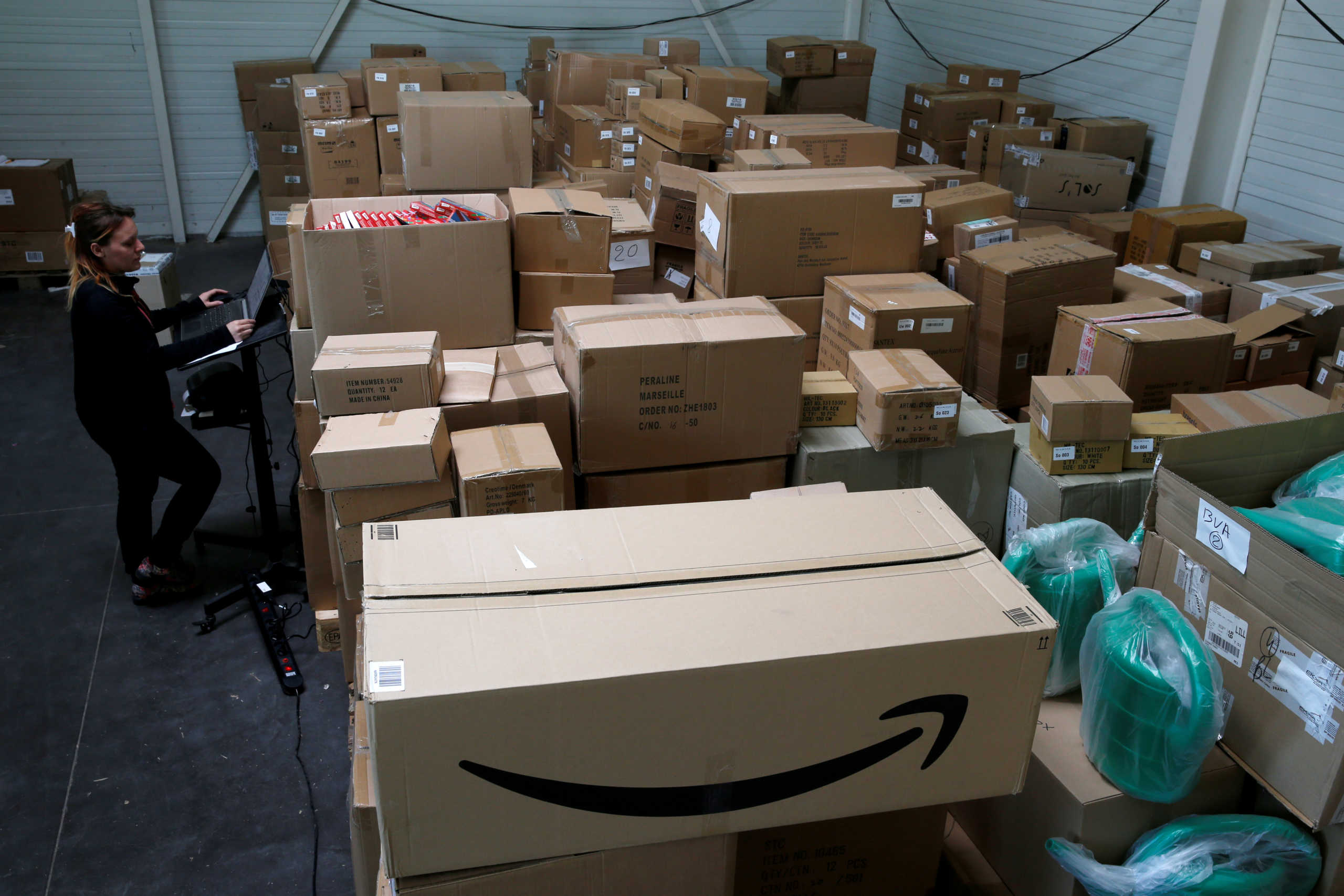 FILE PHOTO: An employee prepares an order for Amazon at Porona warehouse in Bruay-sur-l'Escaut near Valenciennes, France, April 22, 2020. Picture taken, April 22, 2020.  REUTERS