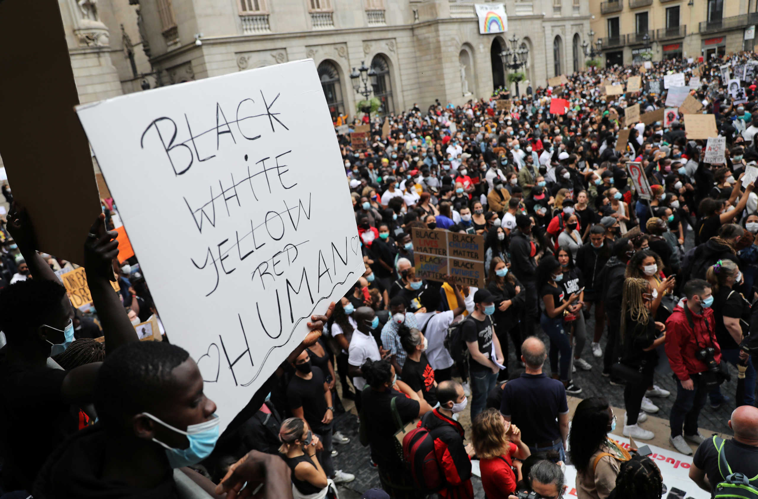 A placard is pictured as people attend a protest against racial inequality in the aftermath of the death in Minneapolis police custody of George Floyd, at Sant Jaume square, Barcelona, Spain June 7, 2020. REUTERS