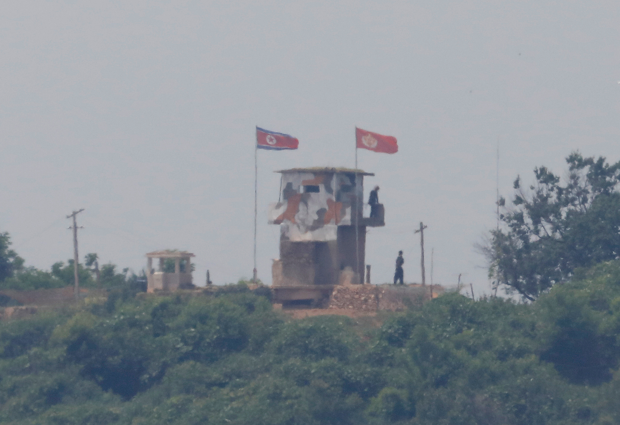 North Korean soldiers are seen at their guard post inside North Korean territory, in this picture taken from Paju, South Korea, near the demilitarized zone (DMZ) separating the two Koreas, June 17, 2020.   REUTERS