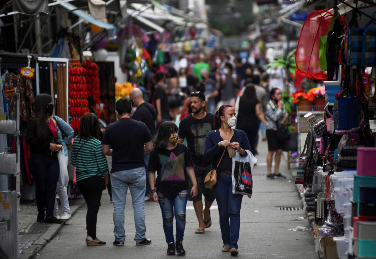 People walk at a popular shopping street, as the city eases restrictions and allows commerce to open, amid the coronavirus disease (COVID-19) outbreak in Rio de Janeiro, Brazil June 29, 2020. REUTERS