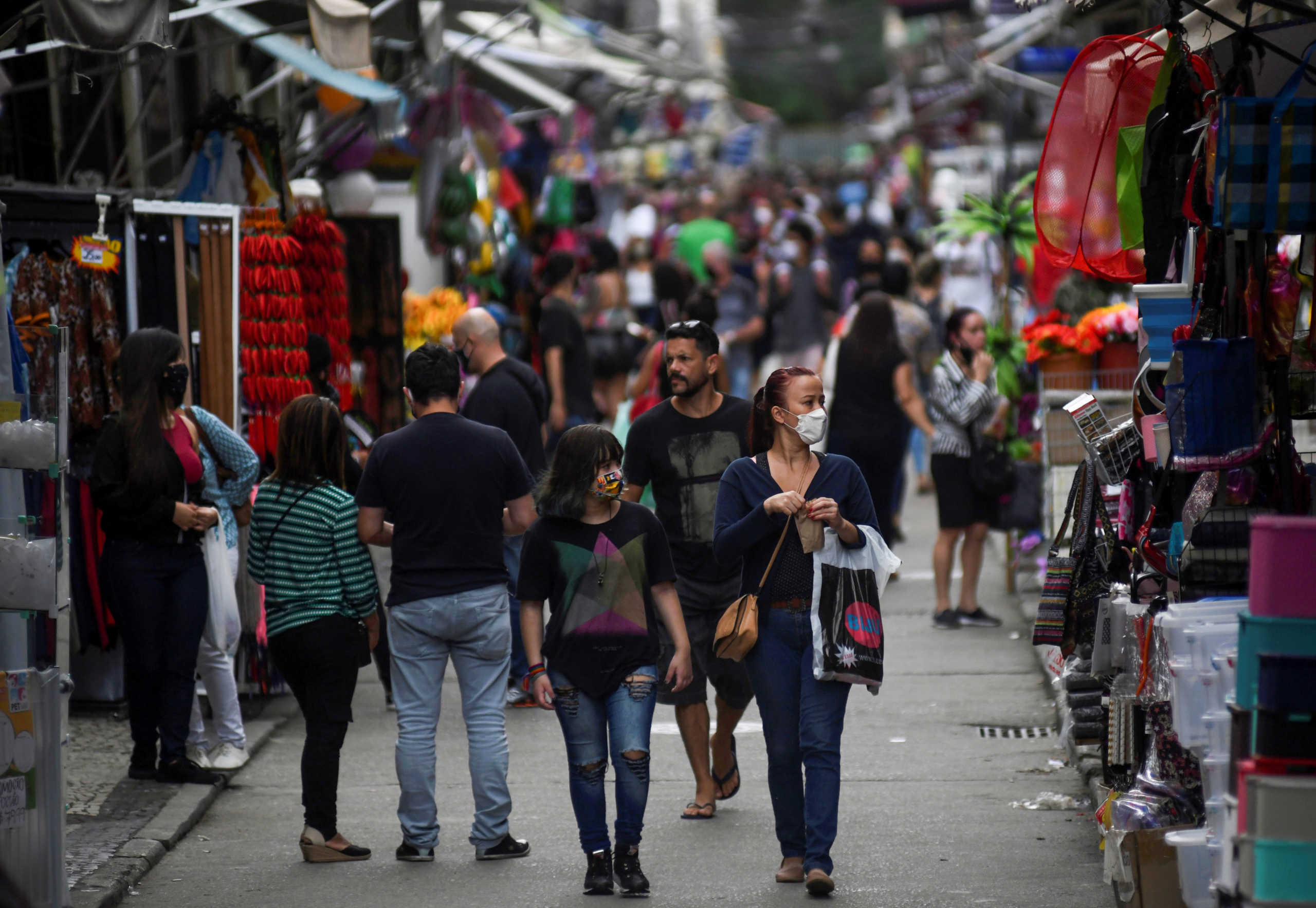 People walk at a popular shopping street, as the city eases restrictions and allows commerce to open, amid the coronavirus disease (COVID-19) outbreak in Rio de Janeiro, Brazil June 29, 2020. REUTERS