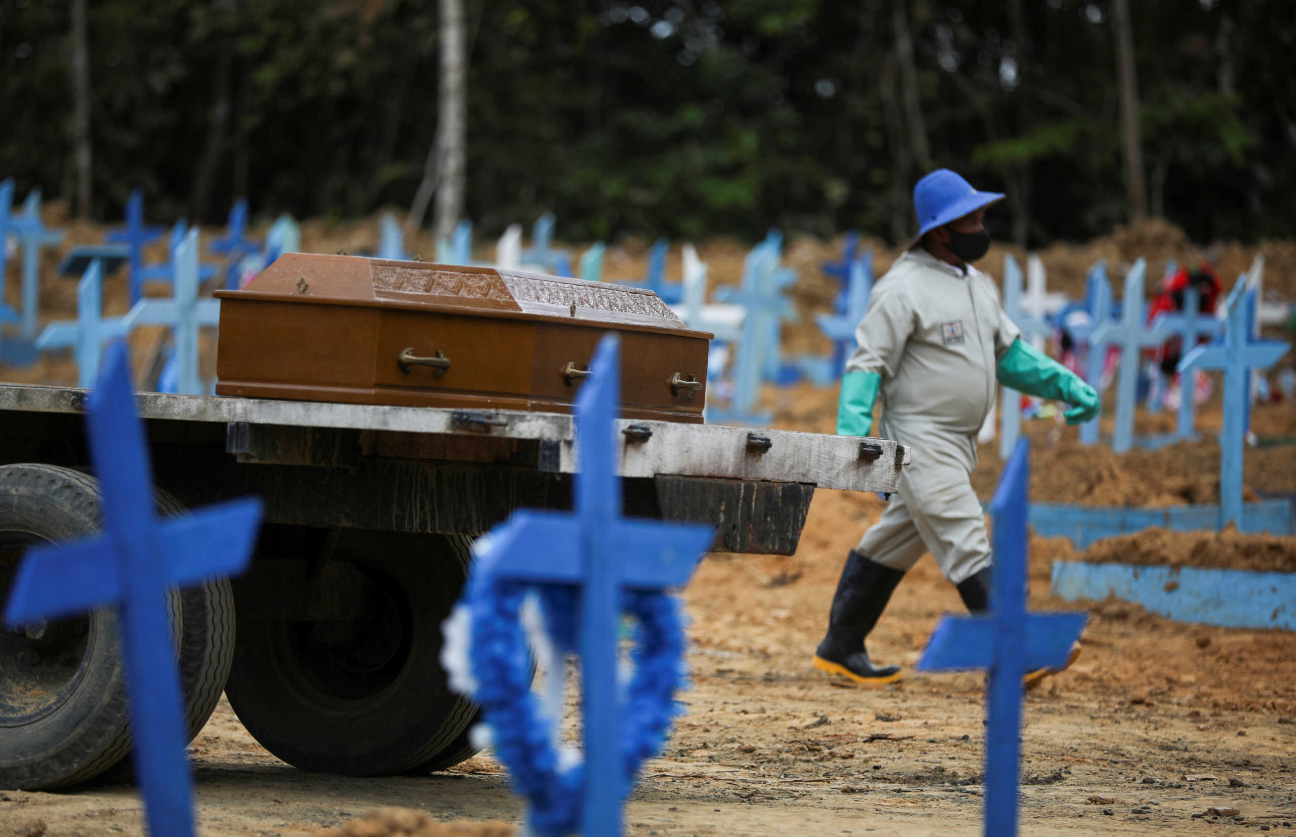 A gravedigger walks next to a coffin at the Parque Taruma cemetery, amid the coronavirus disease (COVID-19) outbreak, in Manaus, Brazil, June 11, 2020.  REUTERS