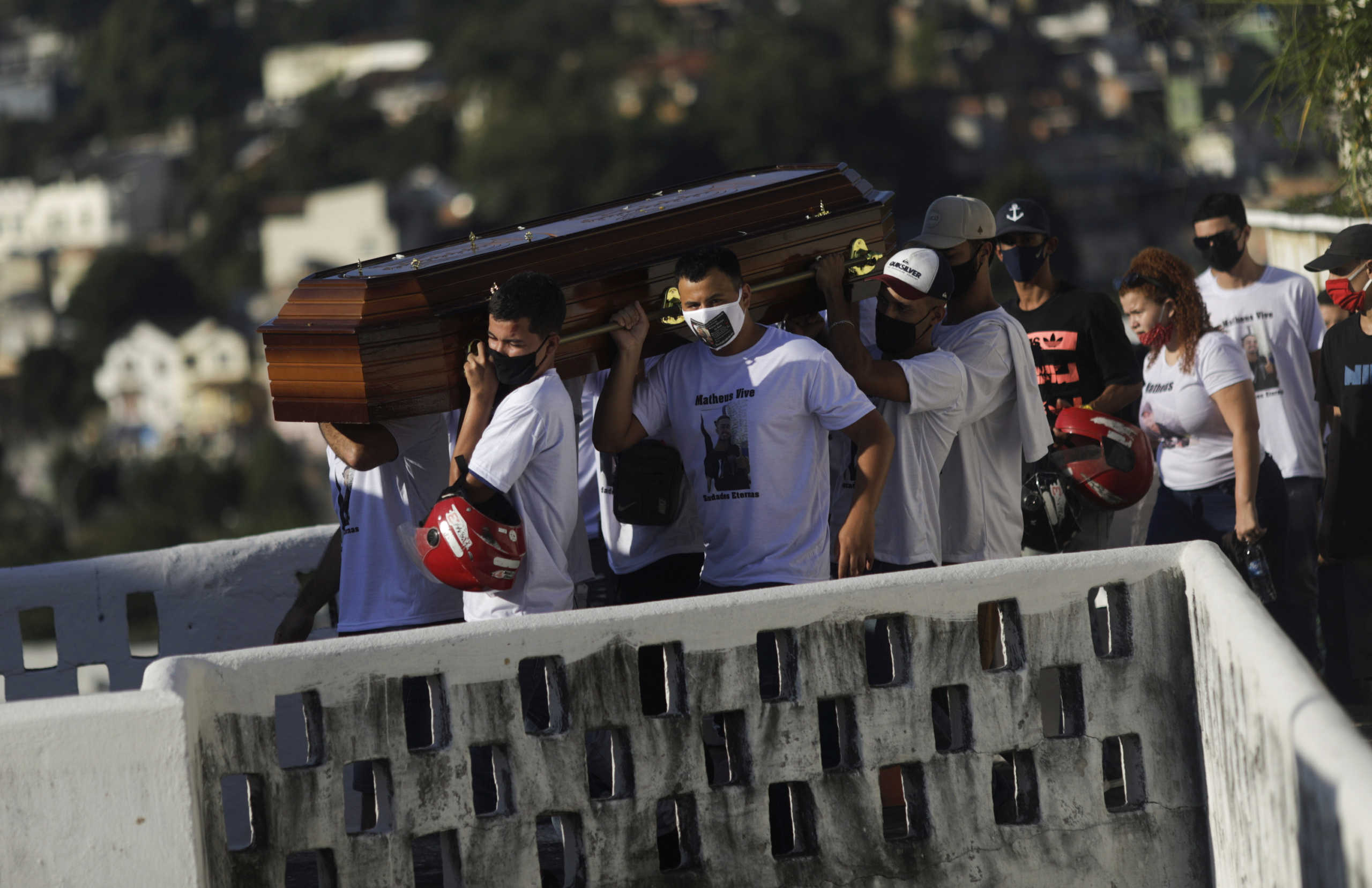 Friends wearing protective masks due to the coronavirus disease (COVID-19) outbreak, carry the coffin during the funeral of Matheus Oliveira, 23, who according to his relatives and neighbours was shot dead during a police action in Catrambi slum, in Rio de Janeiro, Brazil, June 1, 2020. REUTERS