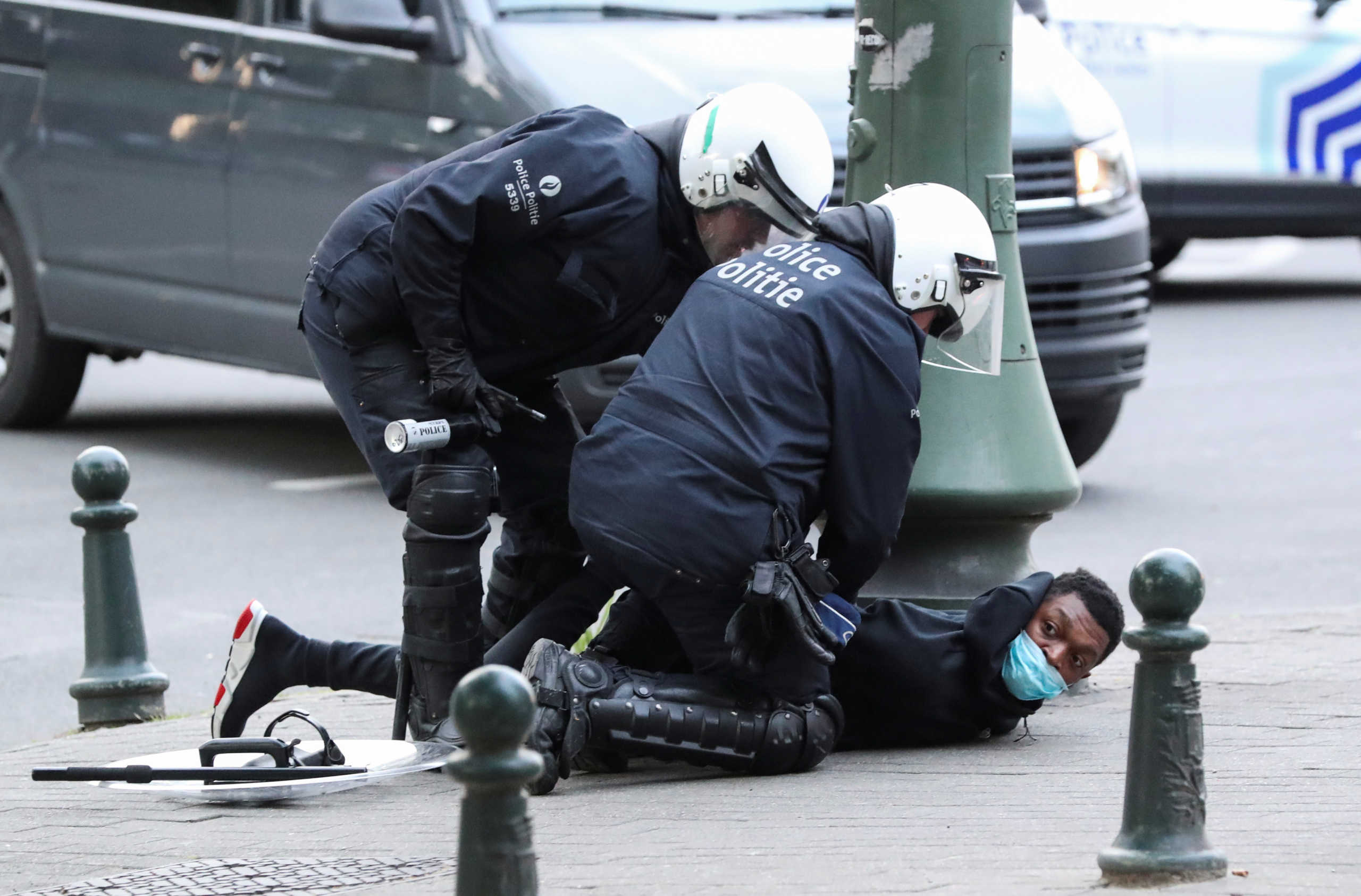 Police officers detain a demonstrator during a protest, organised by Black Lives Matter Belgium, against racial inequality in the aftermath of the death in Minneapolis police custody of George Floyd, in central Brussels, Belgium June 7, 2020. REUTERS