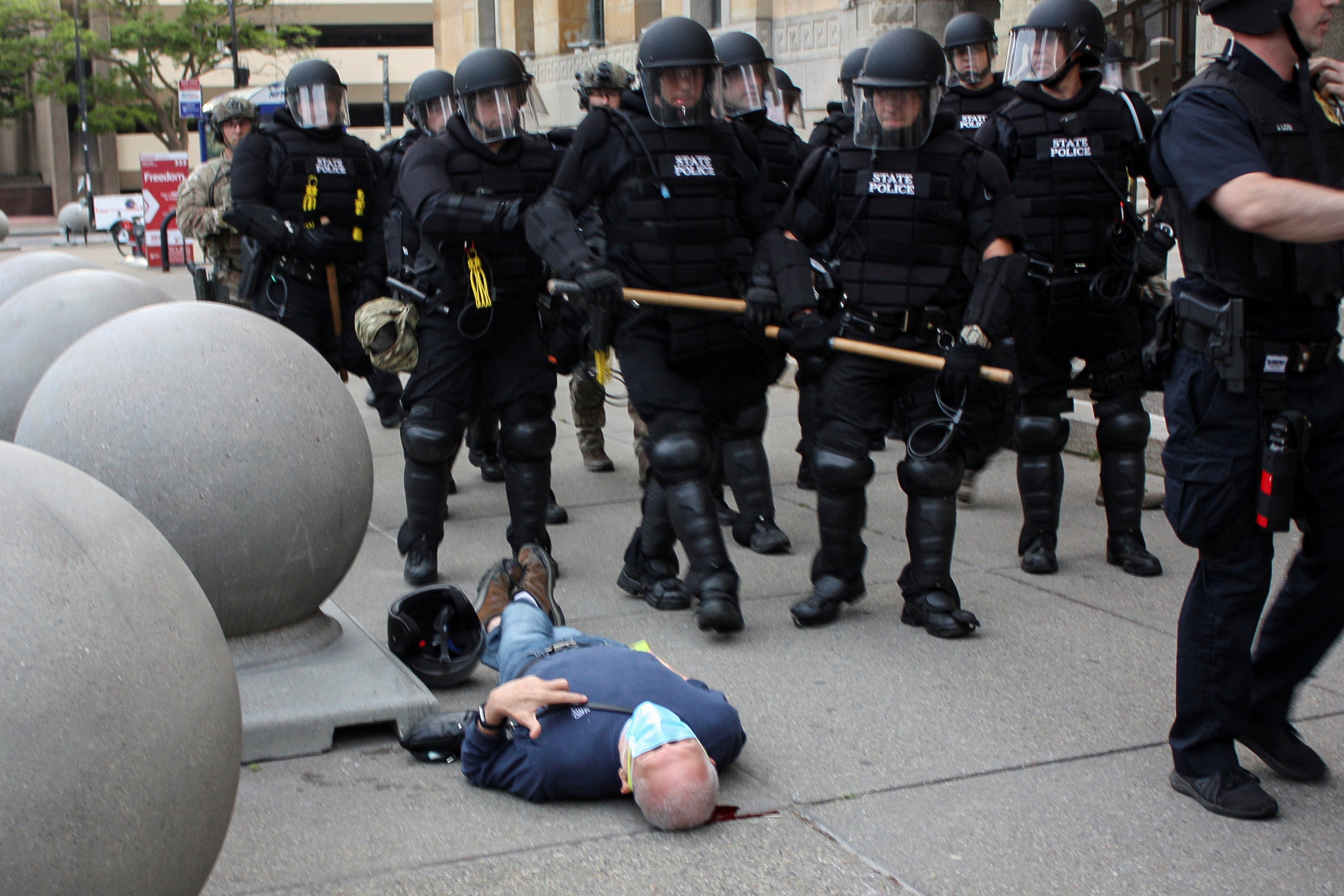 SENSITIVE MATERIAL. THIS IMAGE MAY OFFEND OR DISTURB  Martin Gugino, a 75-year-old protester, lays on the ground after he was shoved by two Buffalo, New York, police officers during a protest against the death in Minneapolis police custody of George Floyd in Niagara Square in Buffalo, New York, U.S., June 4, 2020. Picture taken June 4, 2020. Jamie Quinn