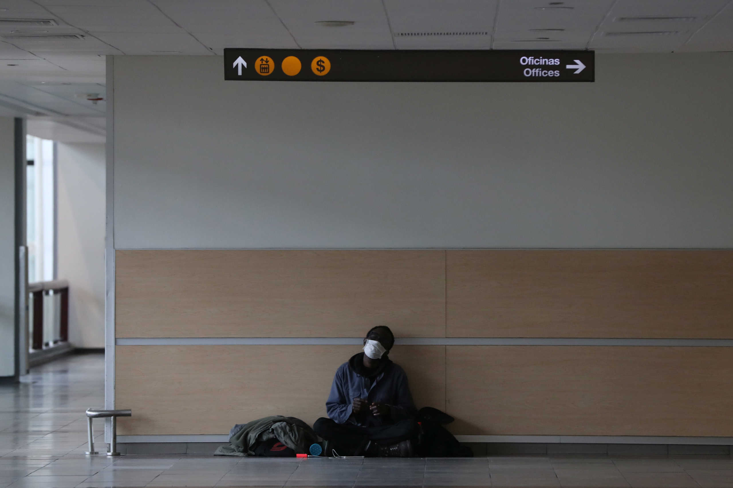 A passenger waits during a general quarantine amid the spread of the coronavirus disease (COVID-19), at the international flights departure area of Arturo Merino Benitez International Airport, in Santiago, Chile May 27, 2020. REUTERS