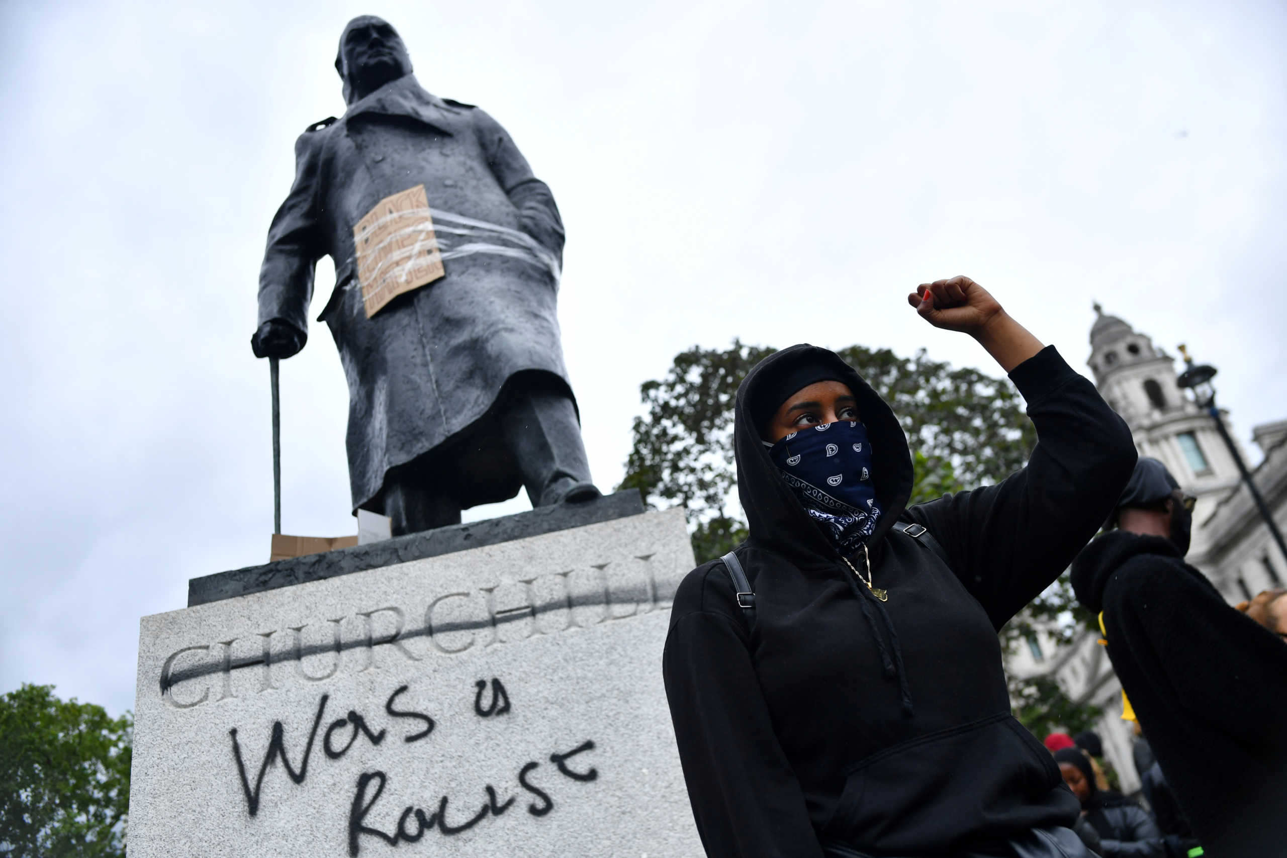 A demonstrator reacts infront of graffiti on a statue of Winston Churchill in Parliament Square during a Black Lives Matter protest in London, following the death of George Floyd who died in police custody in Minneapolis, London, Britain, June 7, 2020. REUTERS