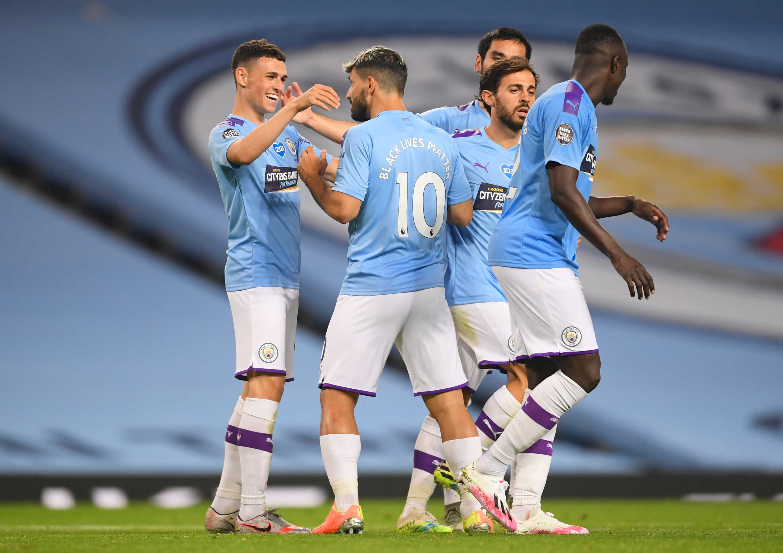 Soccer Football - Premier League - Manchester City v Arsenal - Etihad Stadium, Manchester, Britain - June 17, 2020 Manchester City's Phil Foden celebrates scoring their third goal with Sergio Aguero and teammates as play resumes behind closed doors following the outbreak of the coronavirus disease (COVID-19) Laurence Griffiths