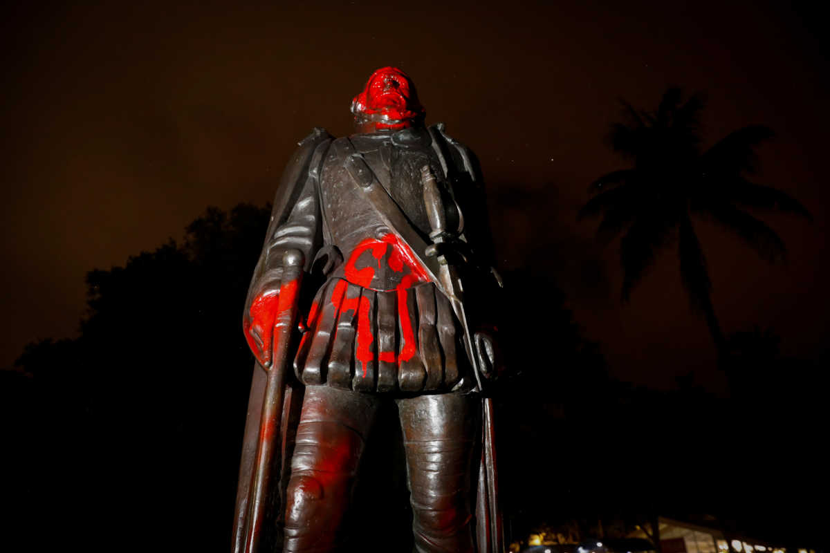 A vandalized statue of Christopher Columbus is seen at the Bayside Marketplace, after a protest against racial inequality in the aftermath of the death in Minneapolis police custody of George Floyd, in Downtown Miami, Florida, U.S., June 10, 2020. REUTERS
