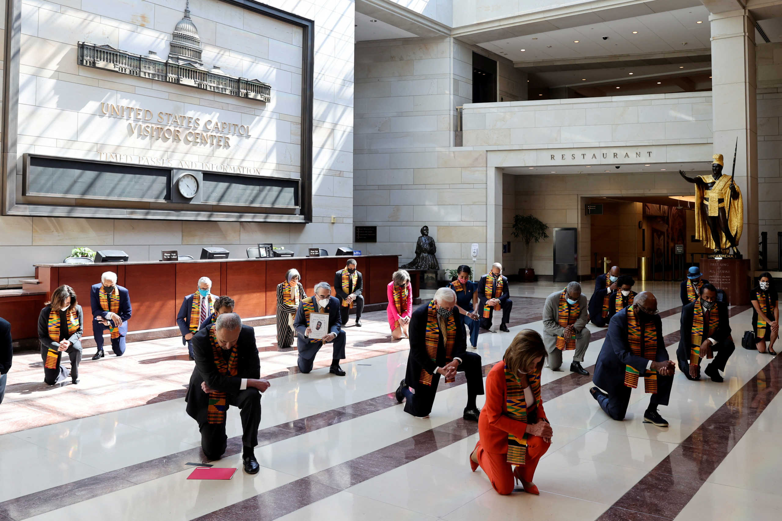 U.S. House Speaker Nancy Pelosi (D-CA) and Senate Minority Leader Chuck Schumer (D-NY) and House Majority Leader Steny Hoyer (D-MD) kneel with Congressional Democrats during a moment of silence to honor George Floyd, Breonna Taylor, Ahmaud Arbery and others inside Emancipation Hall after weeks of protests against racial inequality in the aftermath in Minneapolis police custody of Floyd, at the U.S. Capitol in Washington, U.S., June 8, 2020. REUTERS
