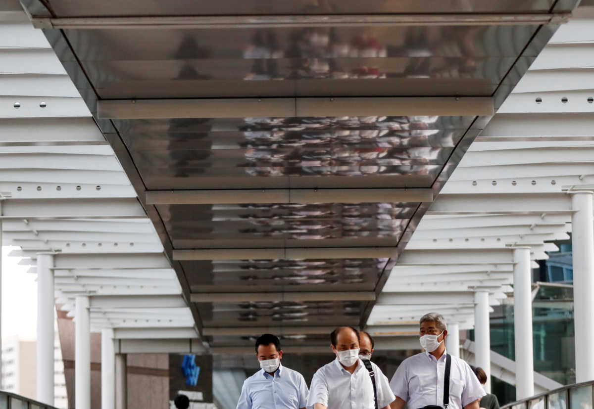Passersby wearing protective face masks head home as the spread of the coronavirus disease (COVID-19) continues, at a station in Tokyo, Japan June 24, 2020.  REUTERS