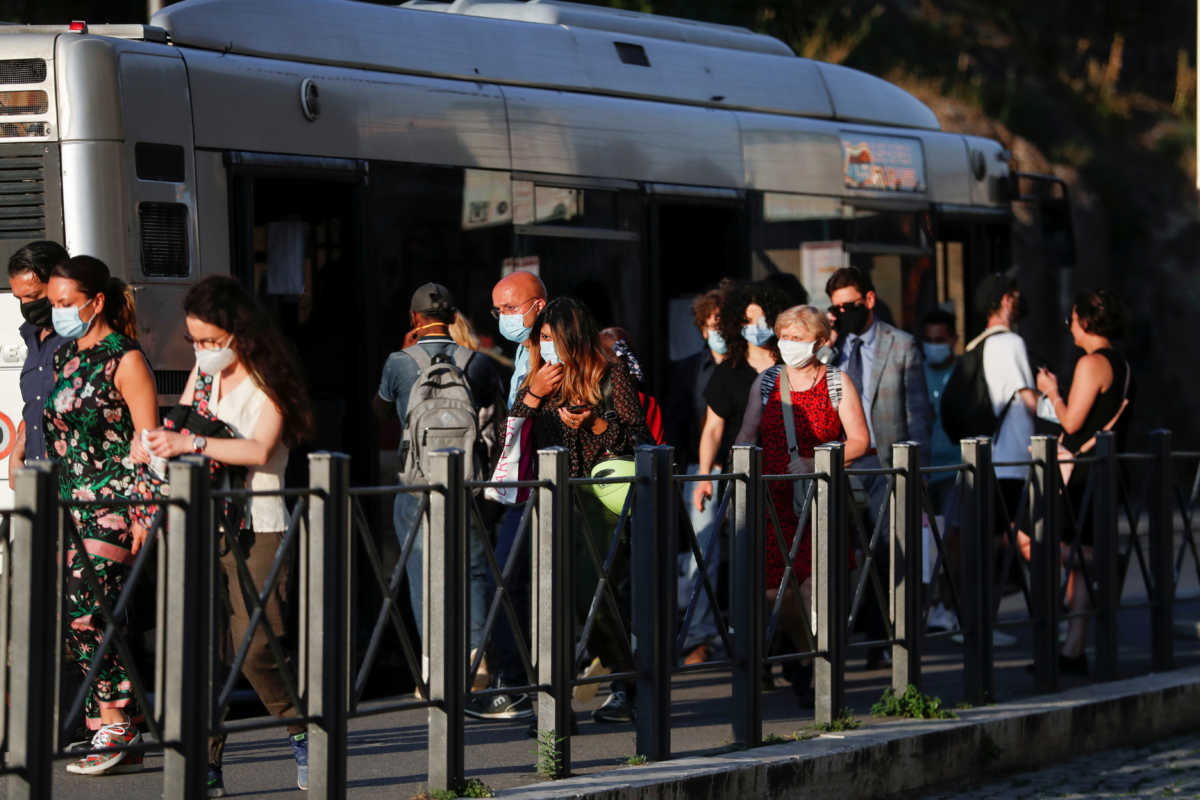 Passengers are seen at the bus stop wearing protective face masks, following the coronavirus disease (COVID-19) outbreak, in Rome, Italy, June 24, 2020. Picture taken June 24, 2020. REUTERS