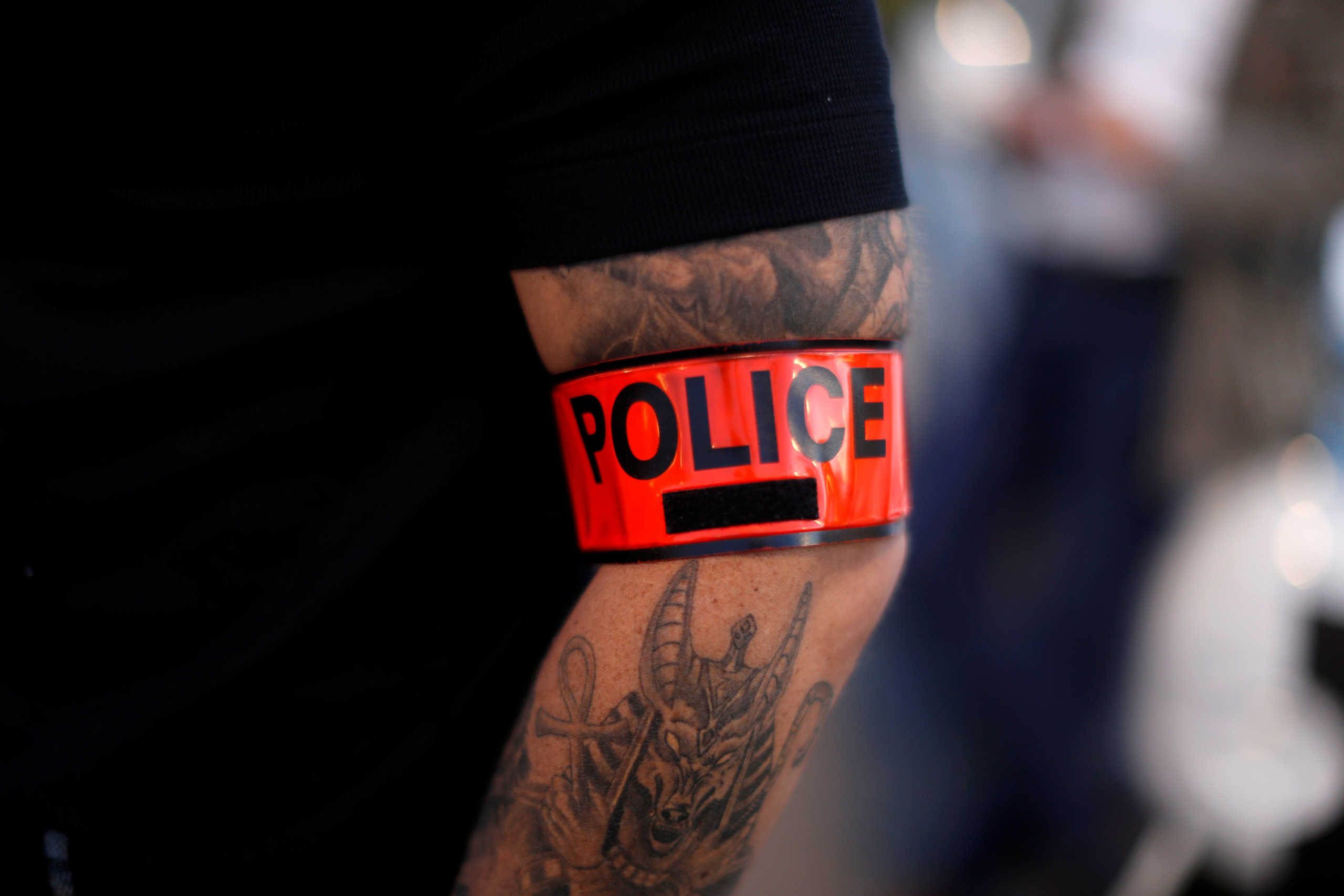 A police officer wears an armband during a demonstration against French Interior Minister Christophe Castaner's reforms, including ditching a controversial chokehold method of arrest, following the death in Minneapolis police custody of George Floyd, in Nice, France June 11, 2020.    REUTERS