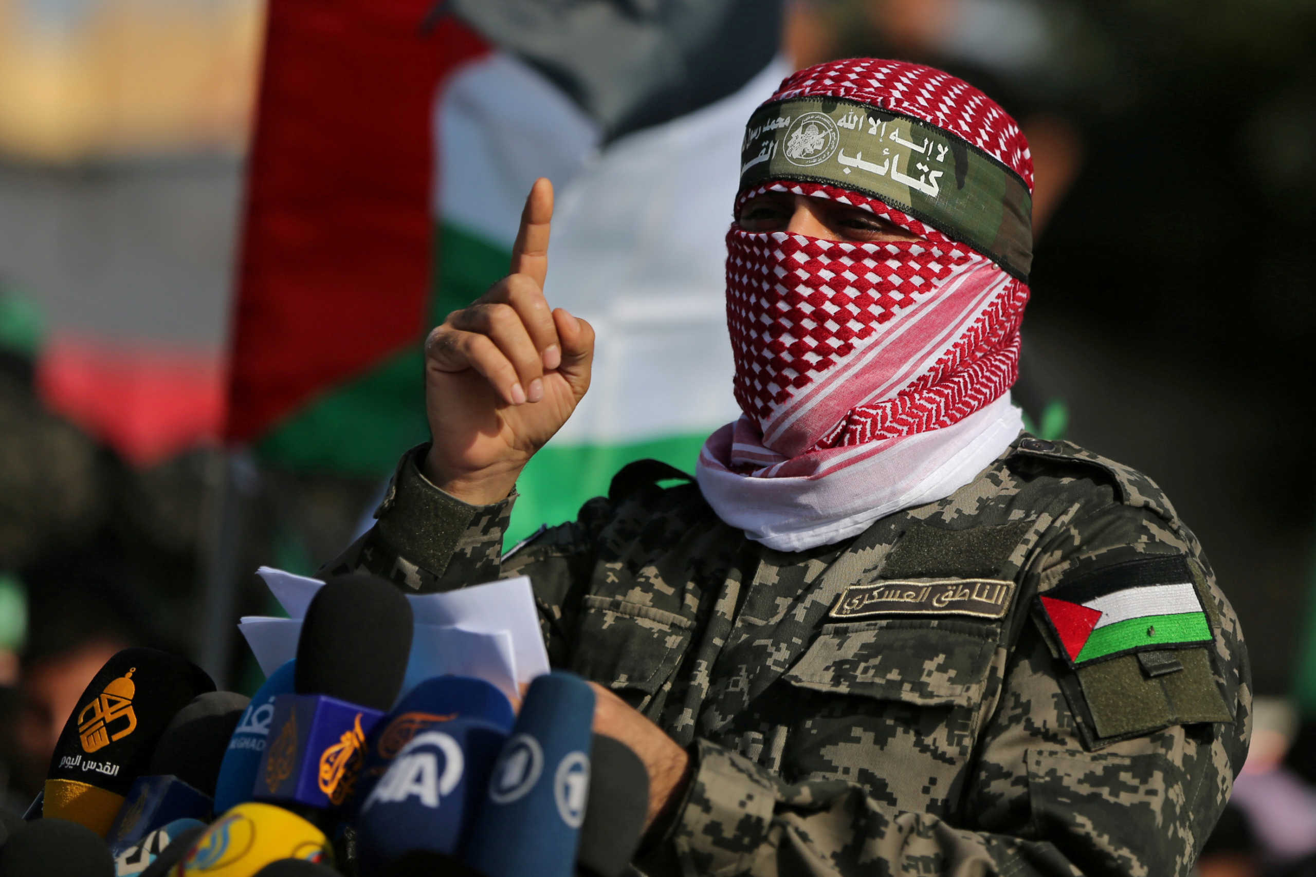 FILE PHOTO: Abu Ubaida, the spokesman of the Izz el-Deen al-Qassam Brigades, gestures as he speaks during an anti-Israel military show in the southern Gaza Strip November 11, 2019. REUTERS