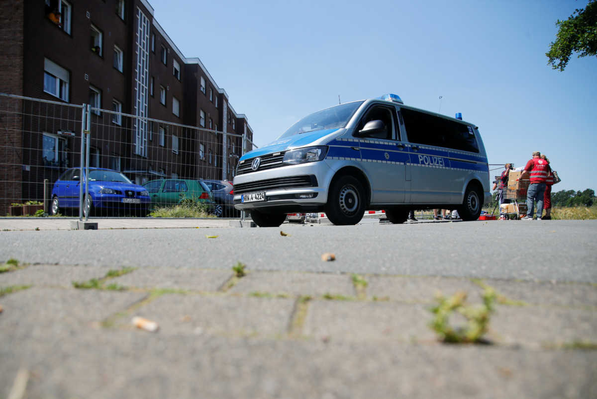 A police van is pictured outside the homes of employees of the Toennies factory, who are under lockdown after a coronavirus disease (COVID-19) outbreak in the meatpacking plant, in Verl, Germany, June 23, 2020. REUTERS