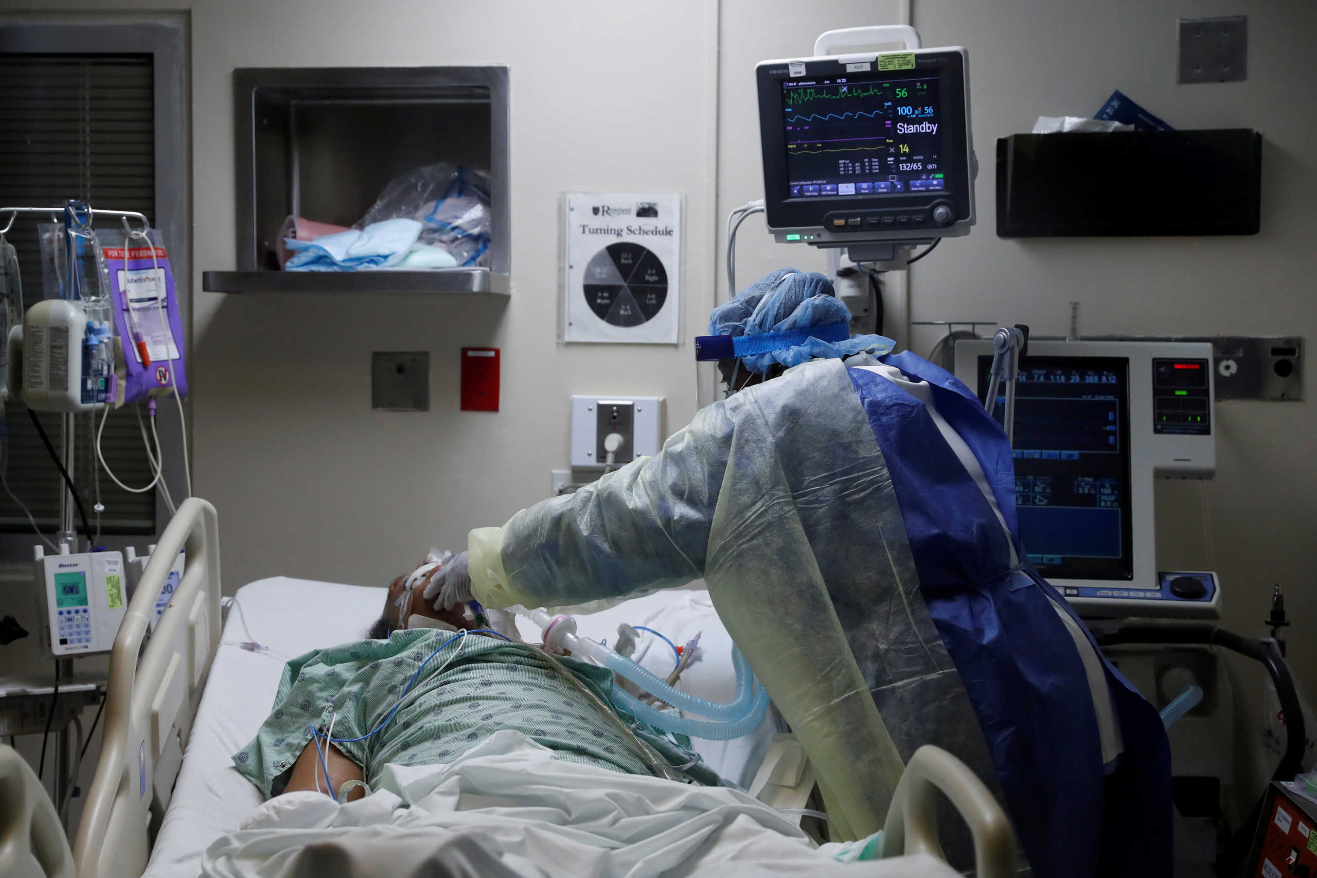 FILE PHOTO: Paula Johnson, a registered nurse, administers a deep suction tube into the lungs of a coronavirus disease (COVID-19) positive patient, in the intensive care unit of Roseland Community Hospital on the South Side of Chicago, Illinois, U.S., April 22, 2020.  REUTERS
