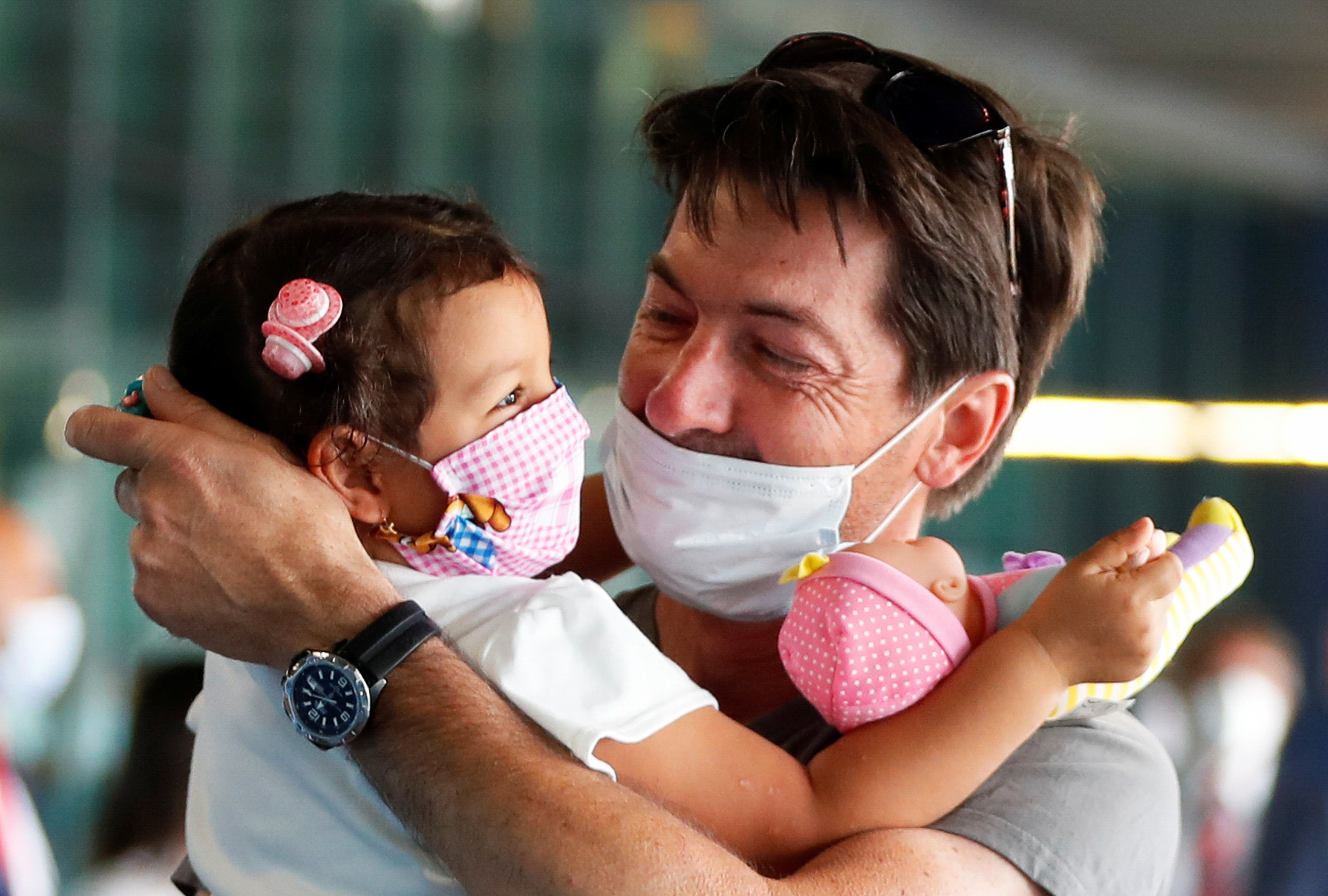 Sandro Manzato from Italy hugs his daughter Yarline, after she came back with his wife Rubiela Perea from Colombia where they were since the 2nd of February, as Italy eases movement between regions, while the country unwinds its rigid lockdown due to the coronavirus disease (COVID-19) outbreak, at Fiumicino Airport, in Rome, Italy June 3, 2020. REUTERS